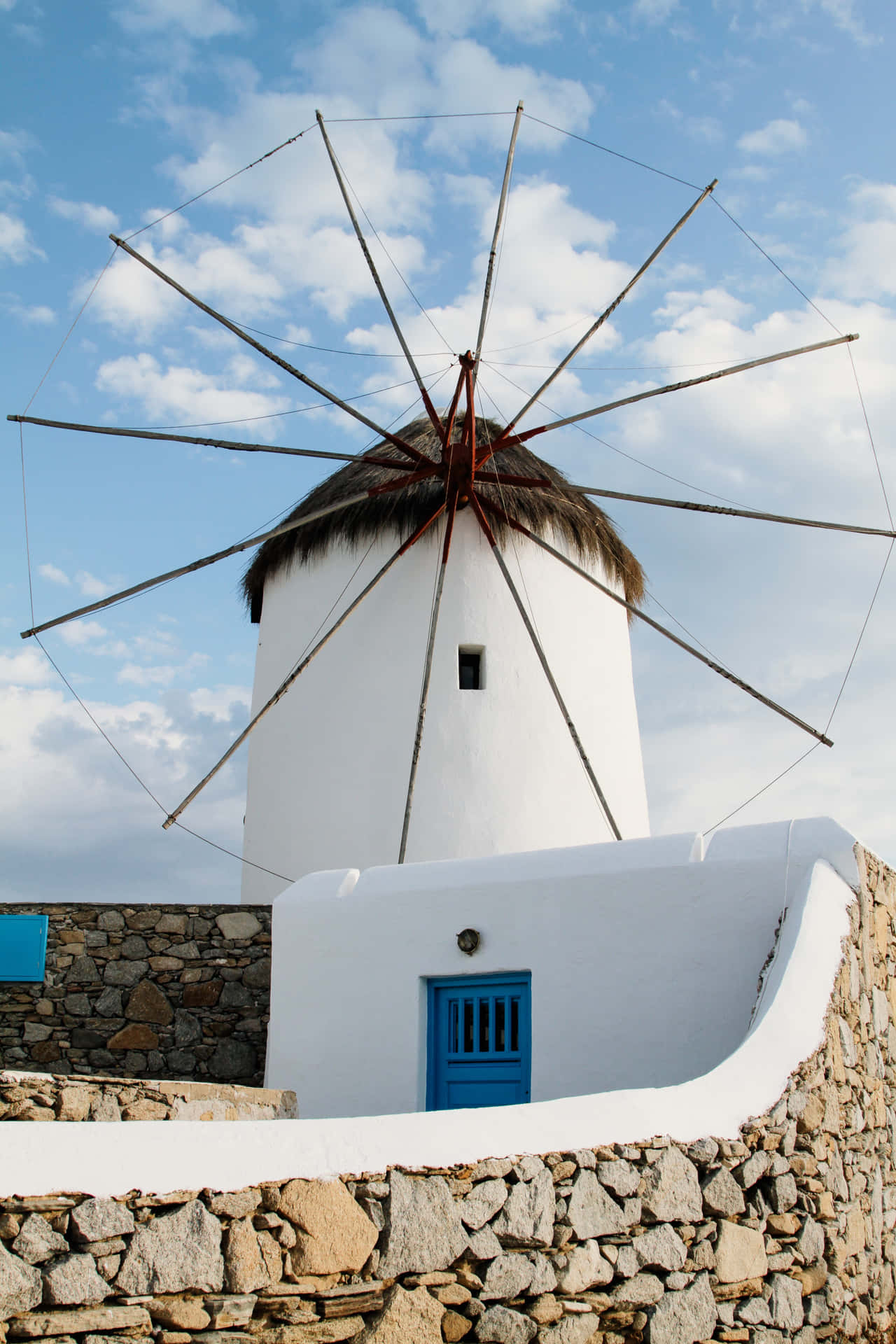 Breathtaking View Of Iconic Mykonos Windmills At Sunset Wallpaper