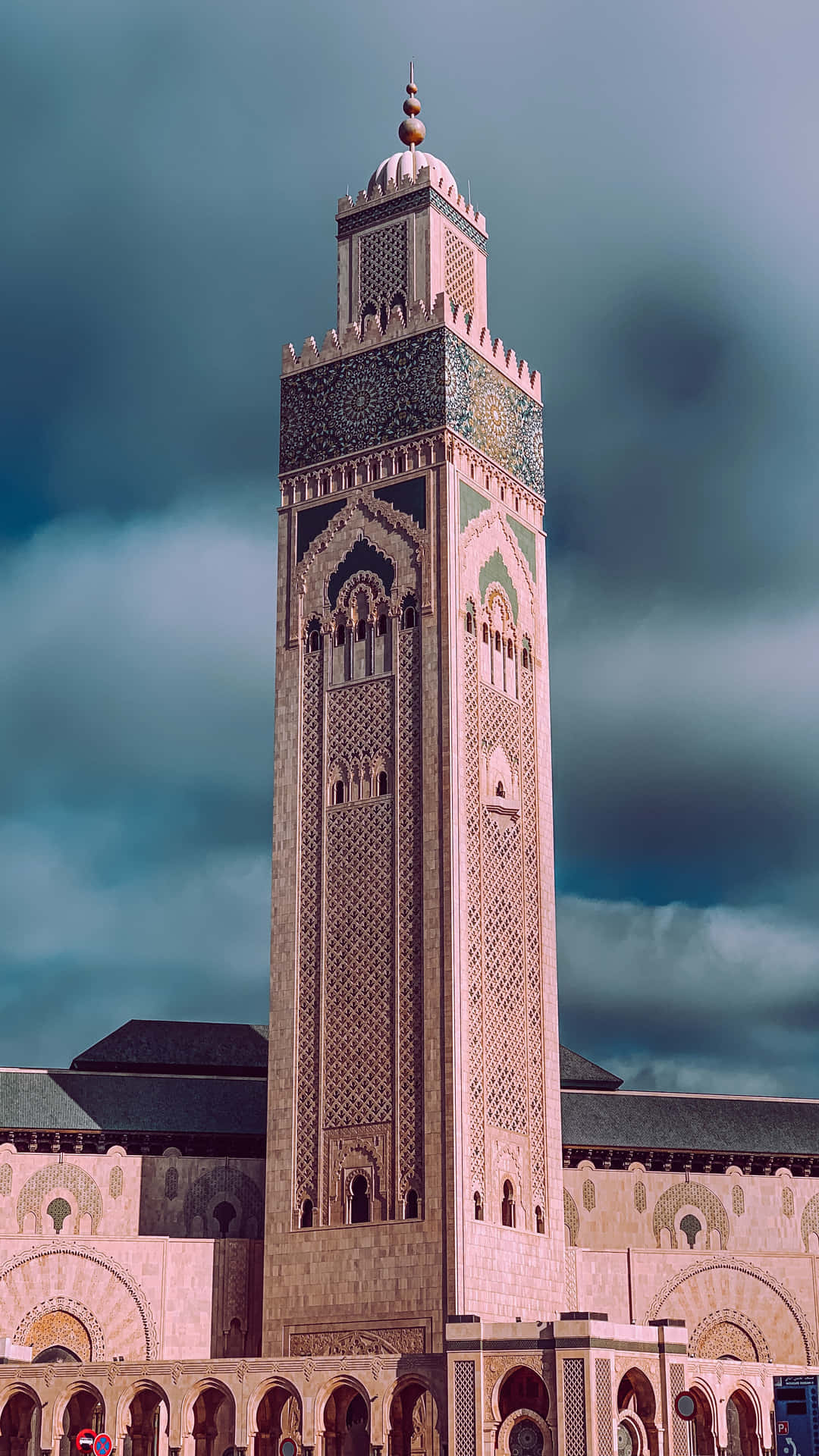 Breathtaking View Of The Iconic Hassan Ii Mosque Against Blue Sky Wallpaper