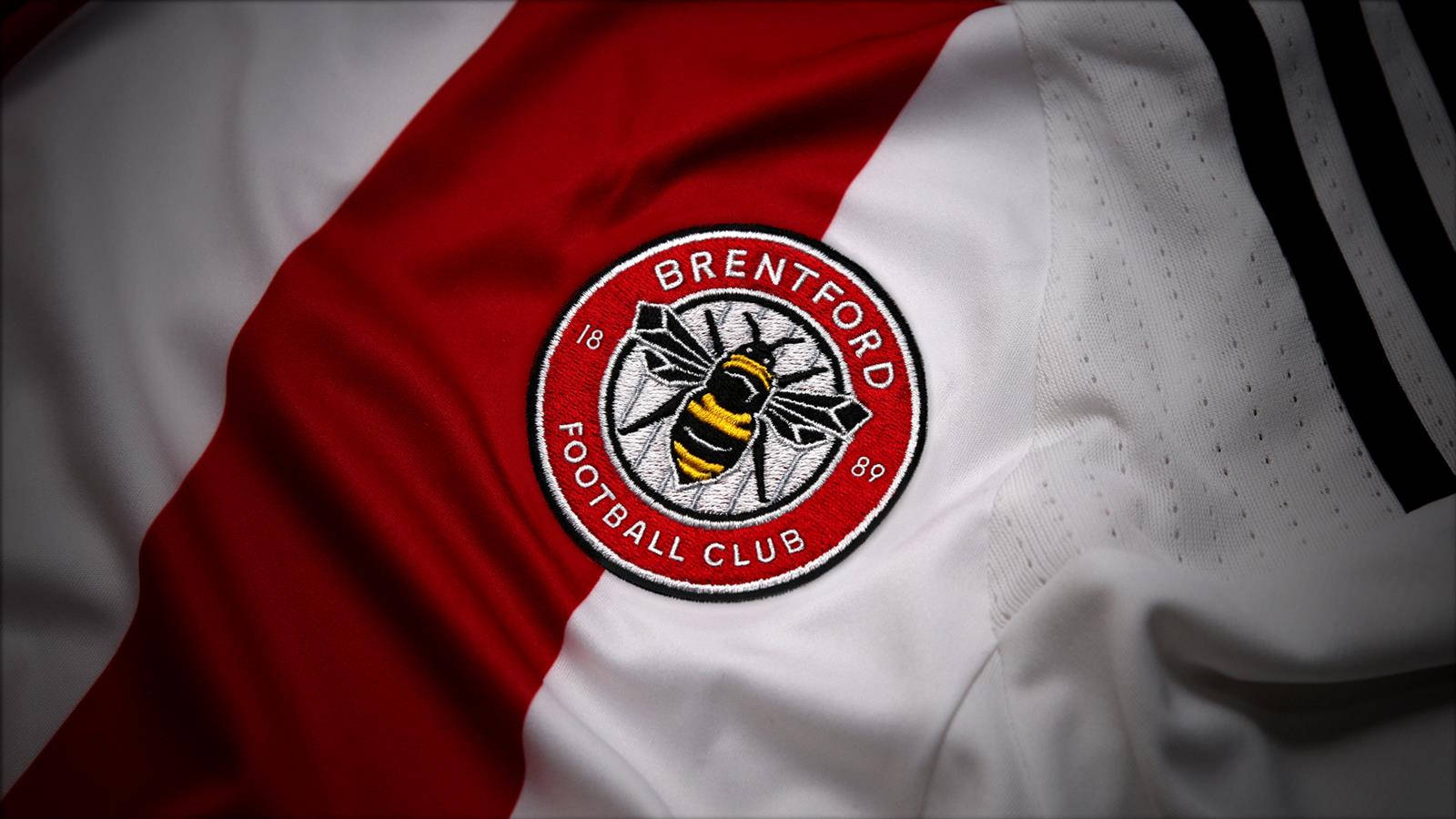 Brentford FC emblem proudly embroidered on a football jersey. Wallpaper