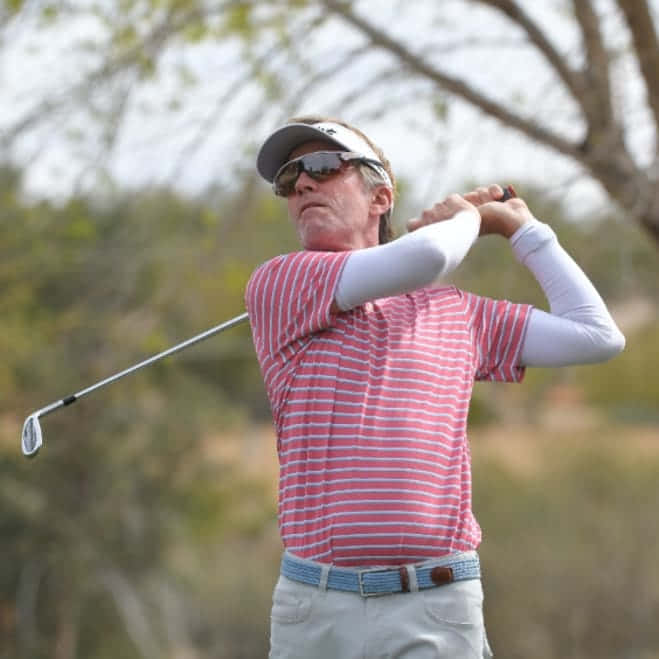 Brett Quigley In Mid-swing During A Golf Tournament Wallpaper