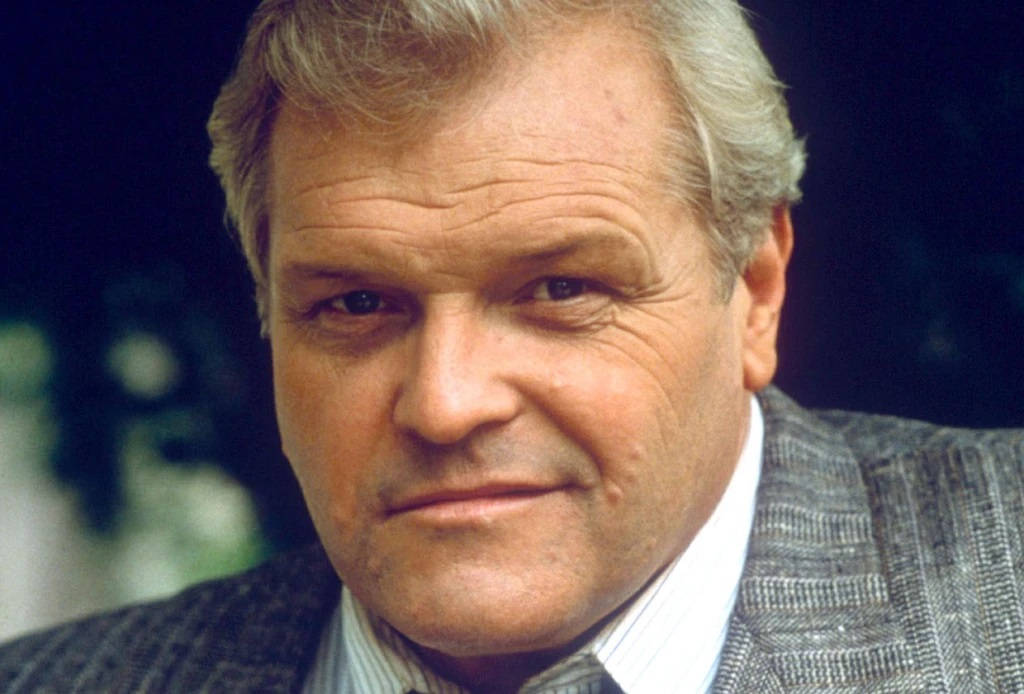Brian Dennehy In Gray Suit Smiling Wallpaper