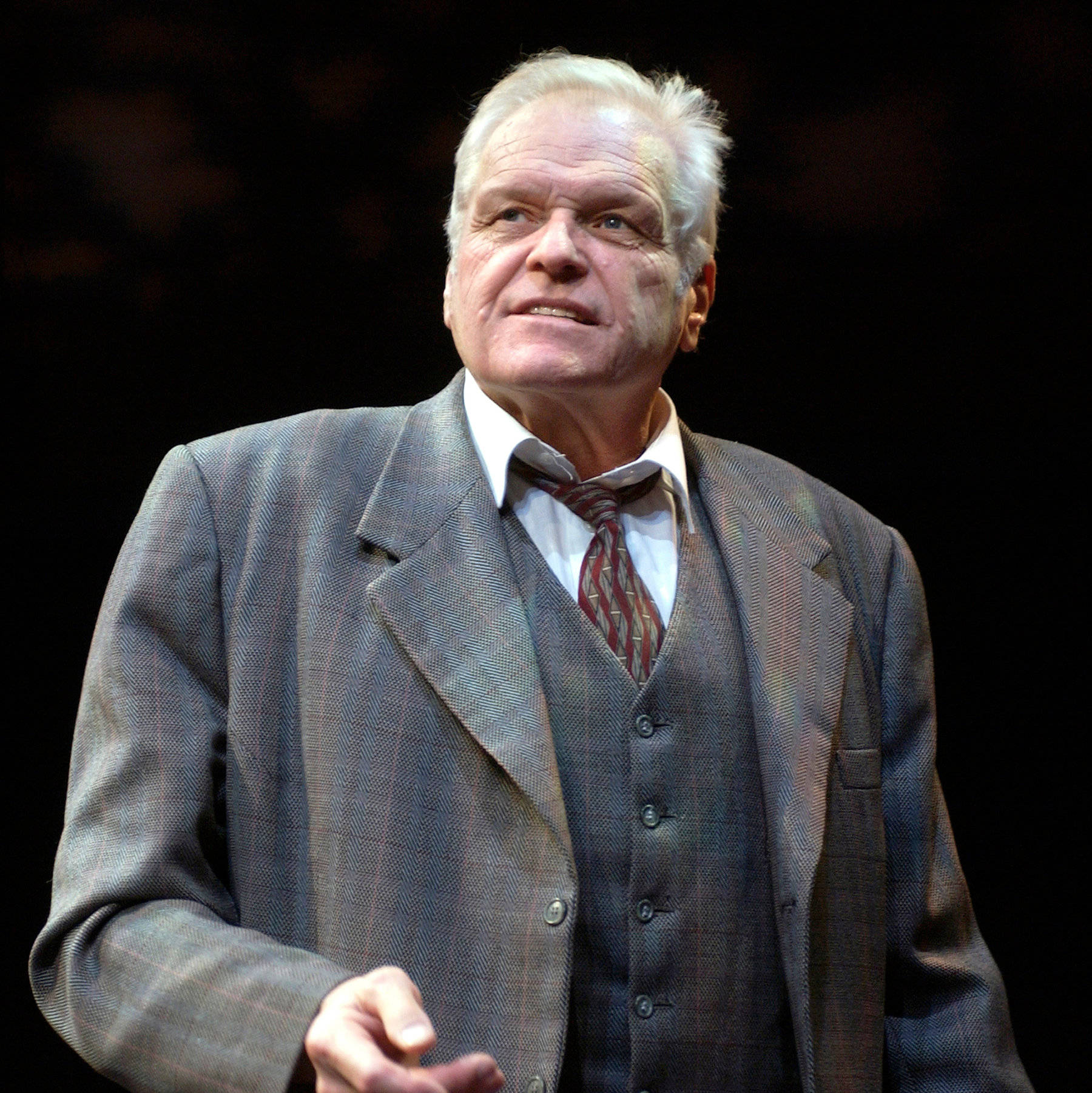 Brian Dennehy Suit And Trenchcoat On Black Wallpaper