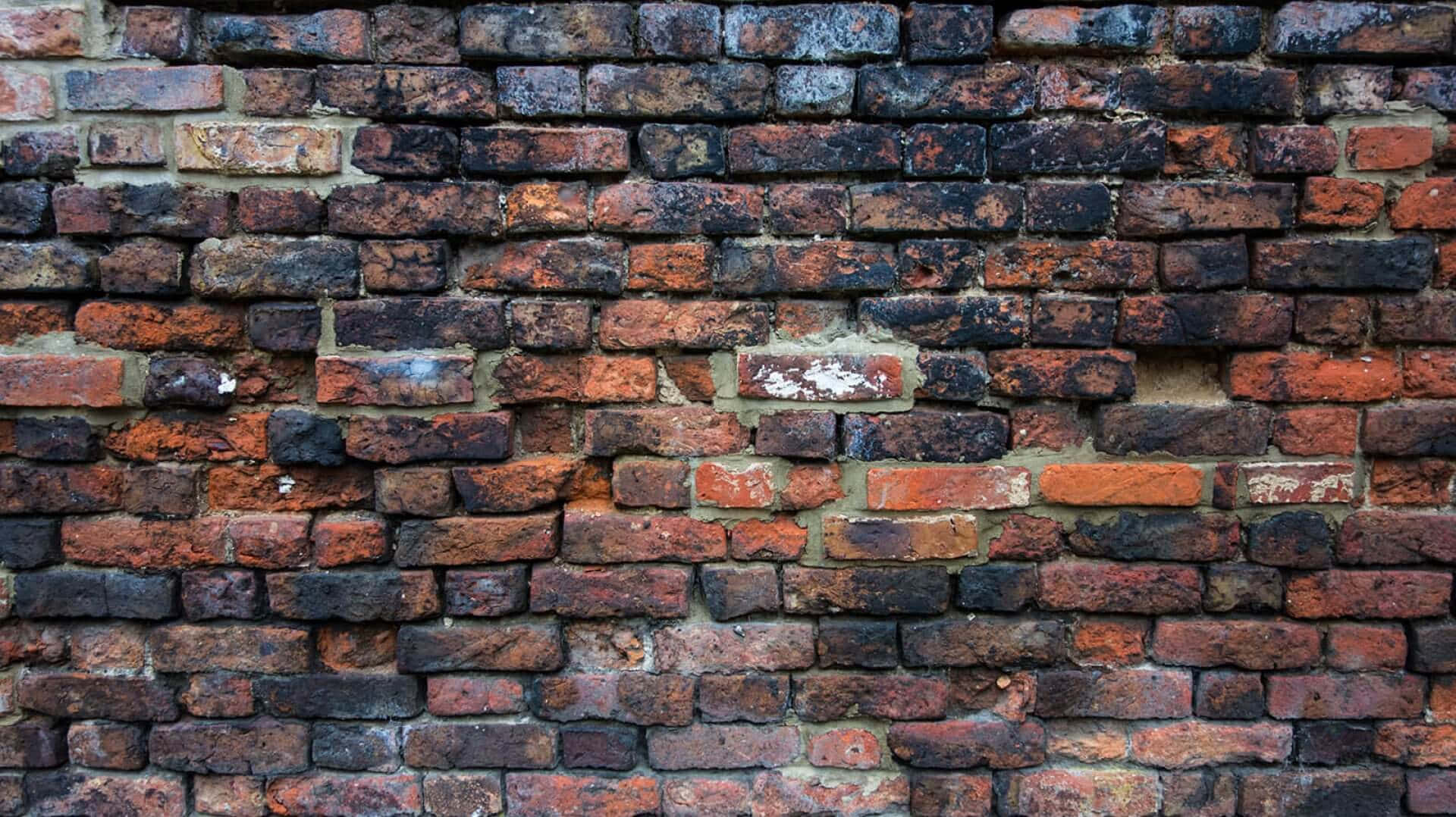 A Brick Wall With A Lot Of Holes In It