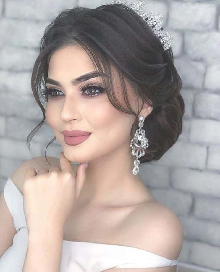 A Beautiful Woman In A White Dress With A Tiara