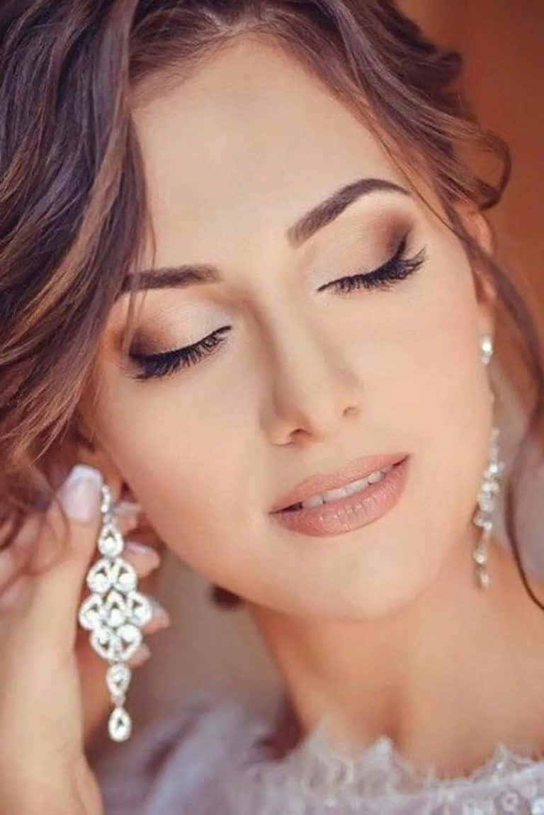 A Beautiful Bride With Her Eyes Closed And Earrings On