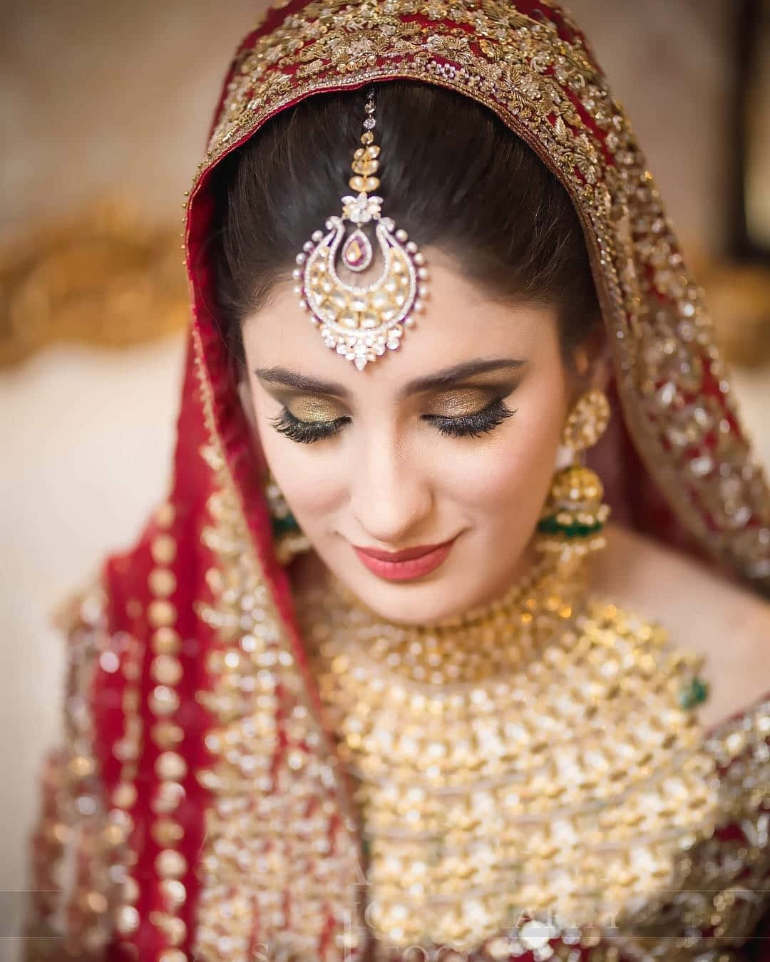 A Bride In A Red And Gold Bridal Outfit