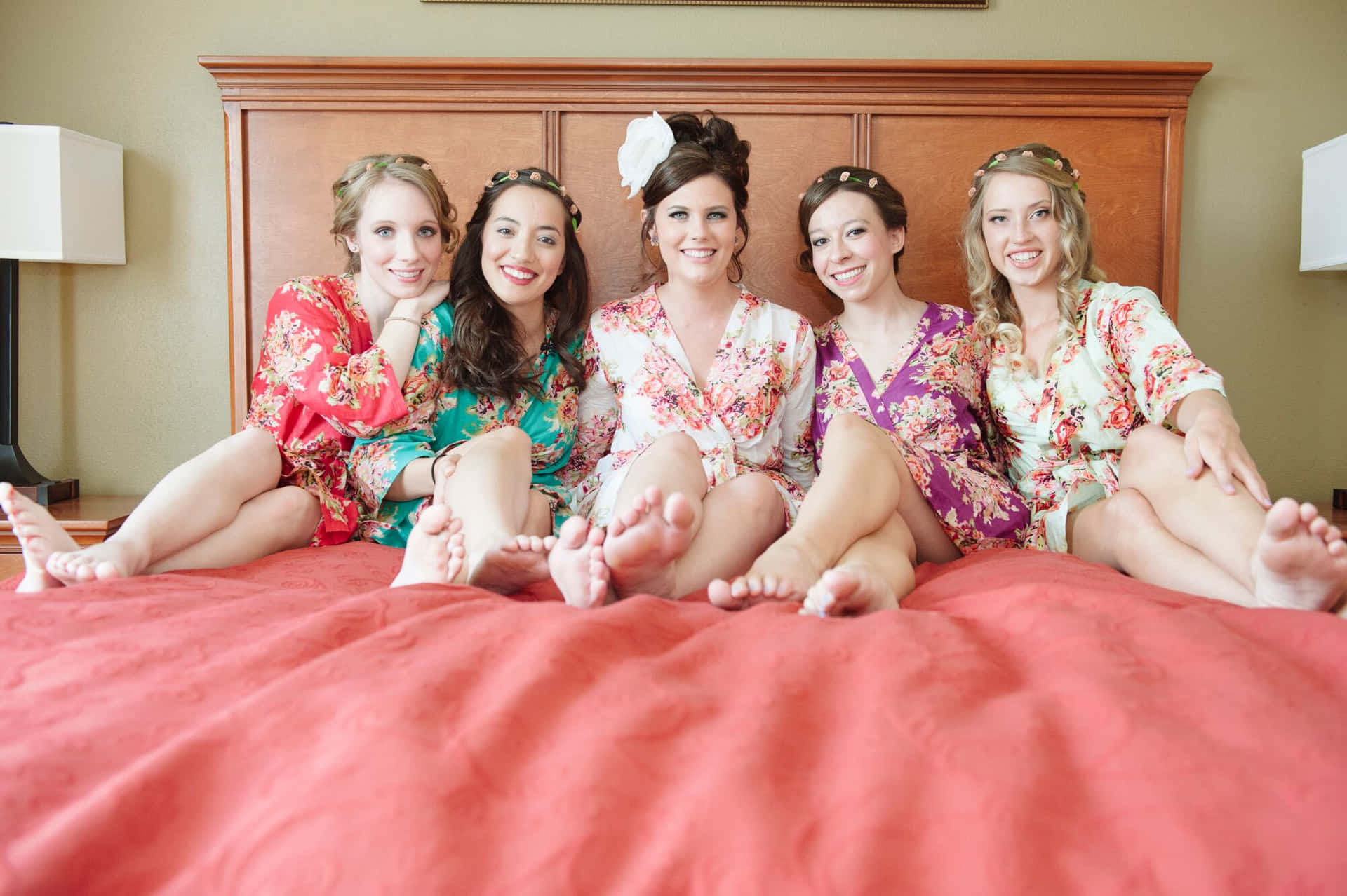 Bride With Bridesmaids Sitting On Bed Picture