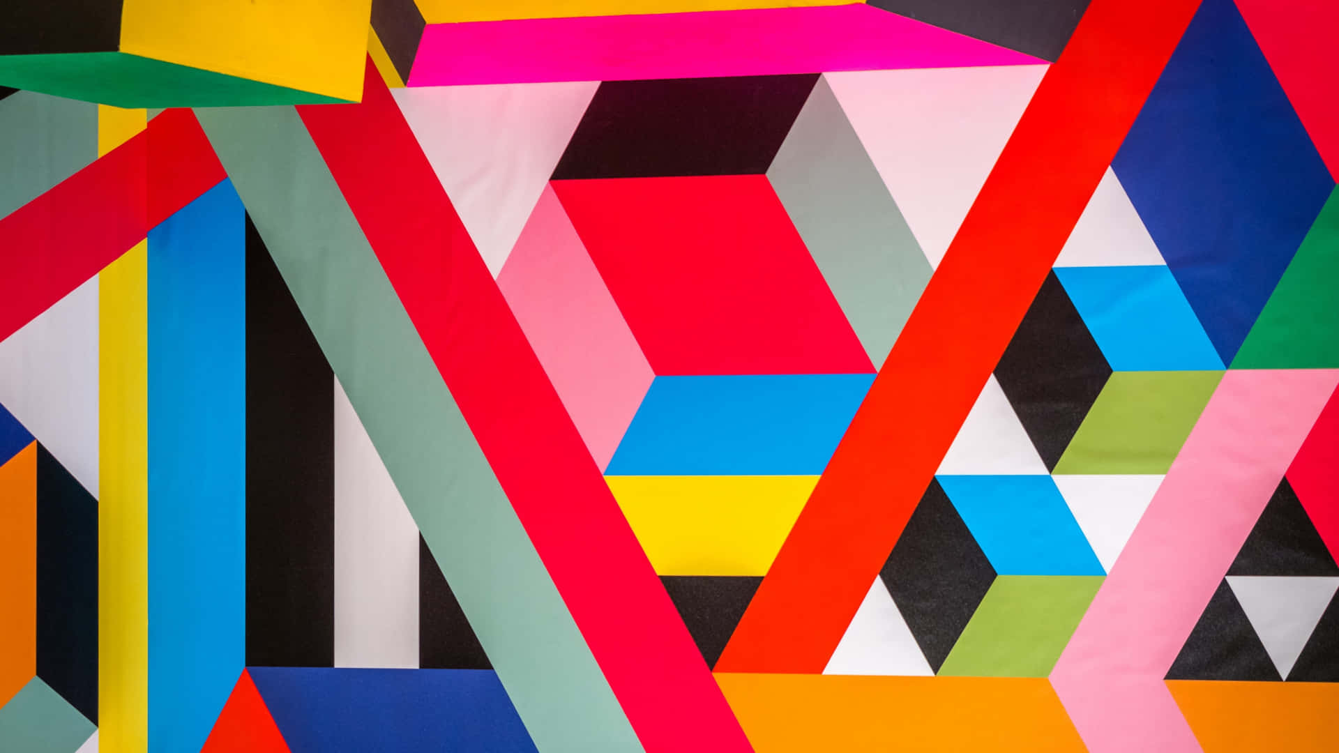 En farverig væg med mange geometriske figurer Wallpaper