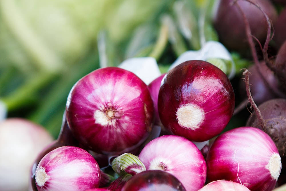 Brilliant Close Up Stack Of Red Onions Wallpaper