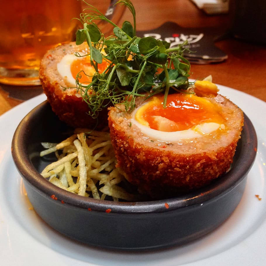 Delightful British Scotch Egg Dish with Pea Tendrils and Fries Wallpaper