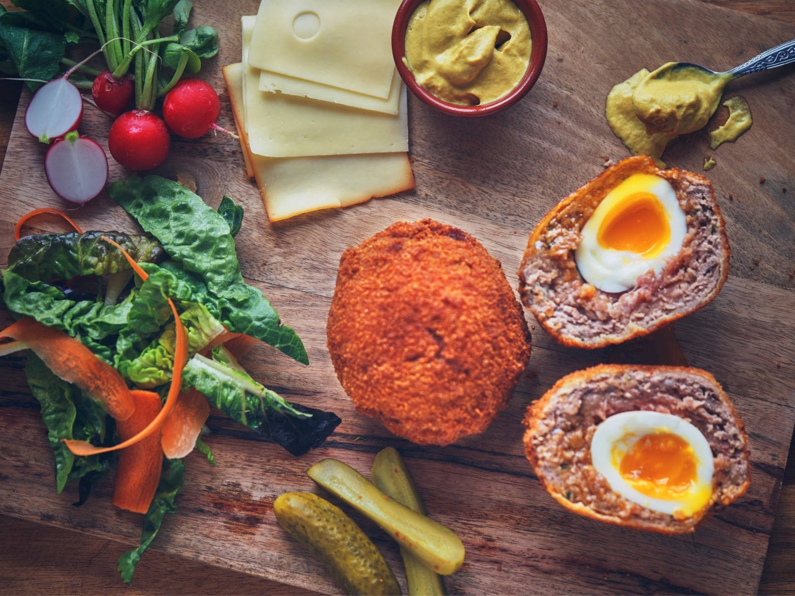 British Scotch Eggs Dish With Cheese And Vegetables Wallpaper