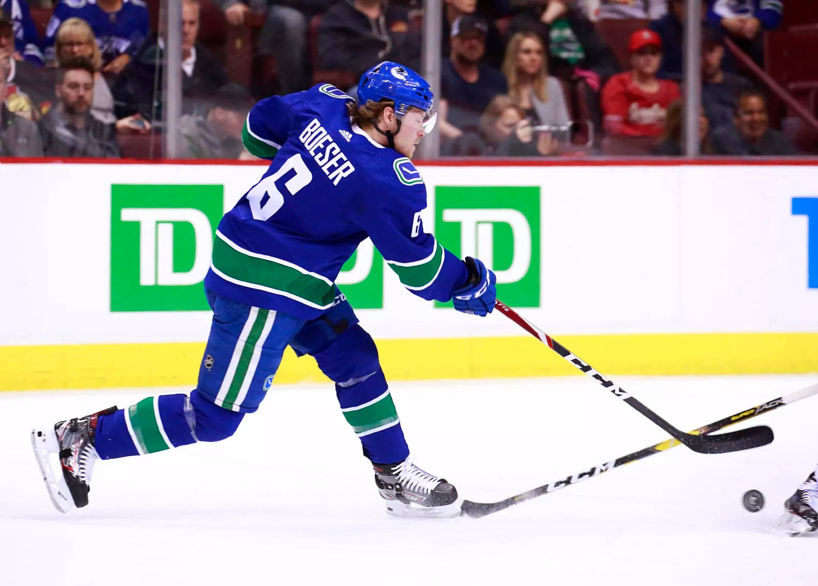 Vancouver Canucks’ Star Player, Brock Boeser, in Action against Calgary Flames Wallpaper