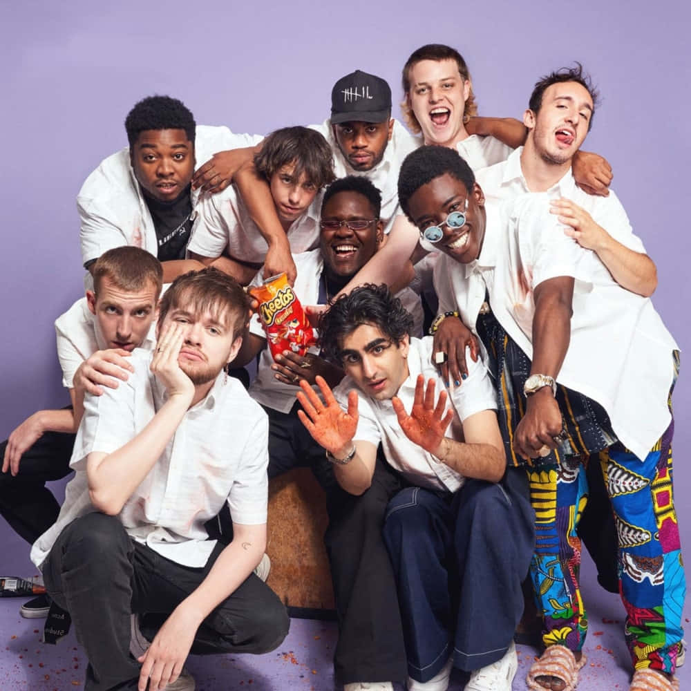 Diverse group of Brockhampton members on a rooftop Wallpaper