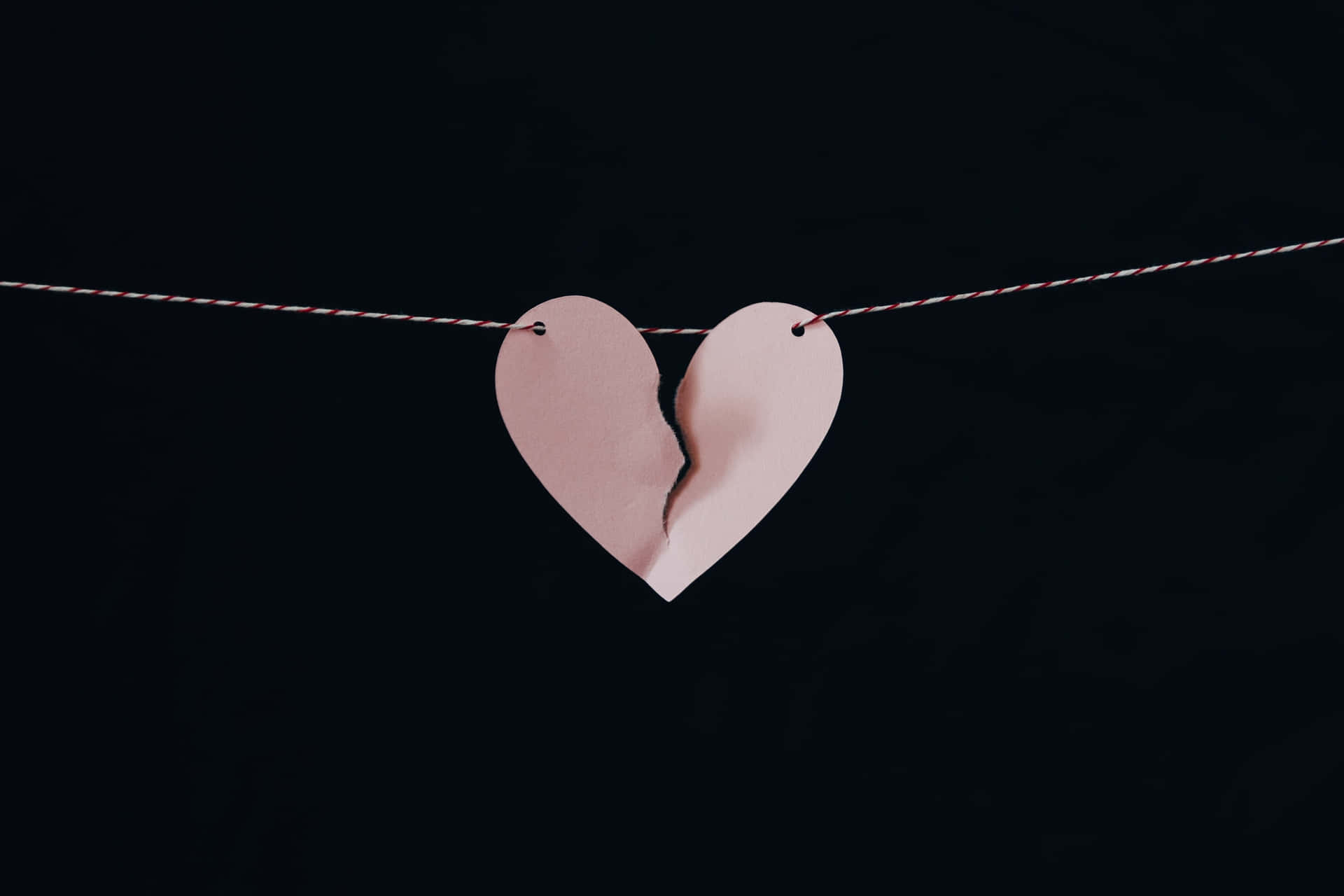 Broken Heart Suspendedon String Wallpaper