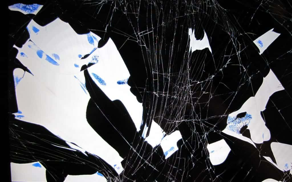 A Broken Window With Blue And White Shattered Glass Wallpaper