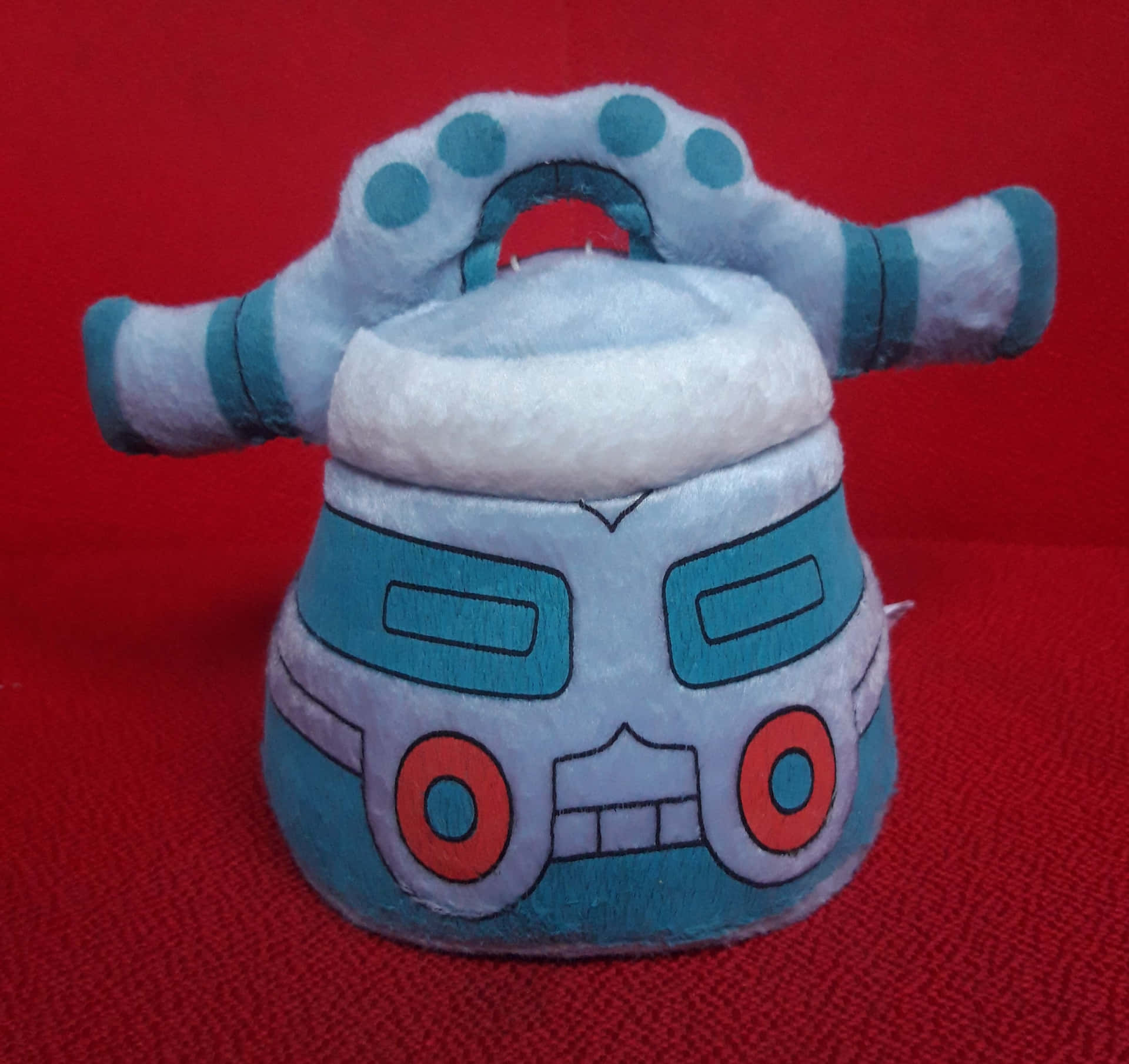 Bronzong Plush Toy On Red Background Wallpaper