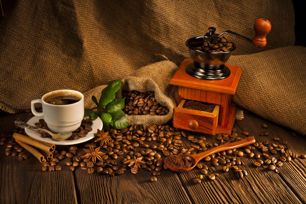 Aromatic Brown Coffee Beans with Steaming Cup Wallpaper