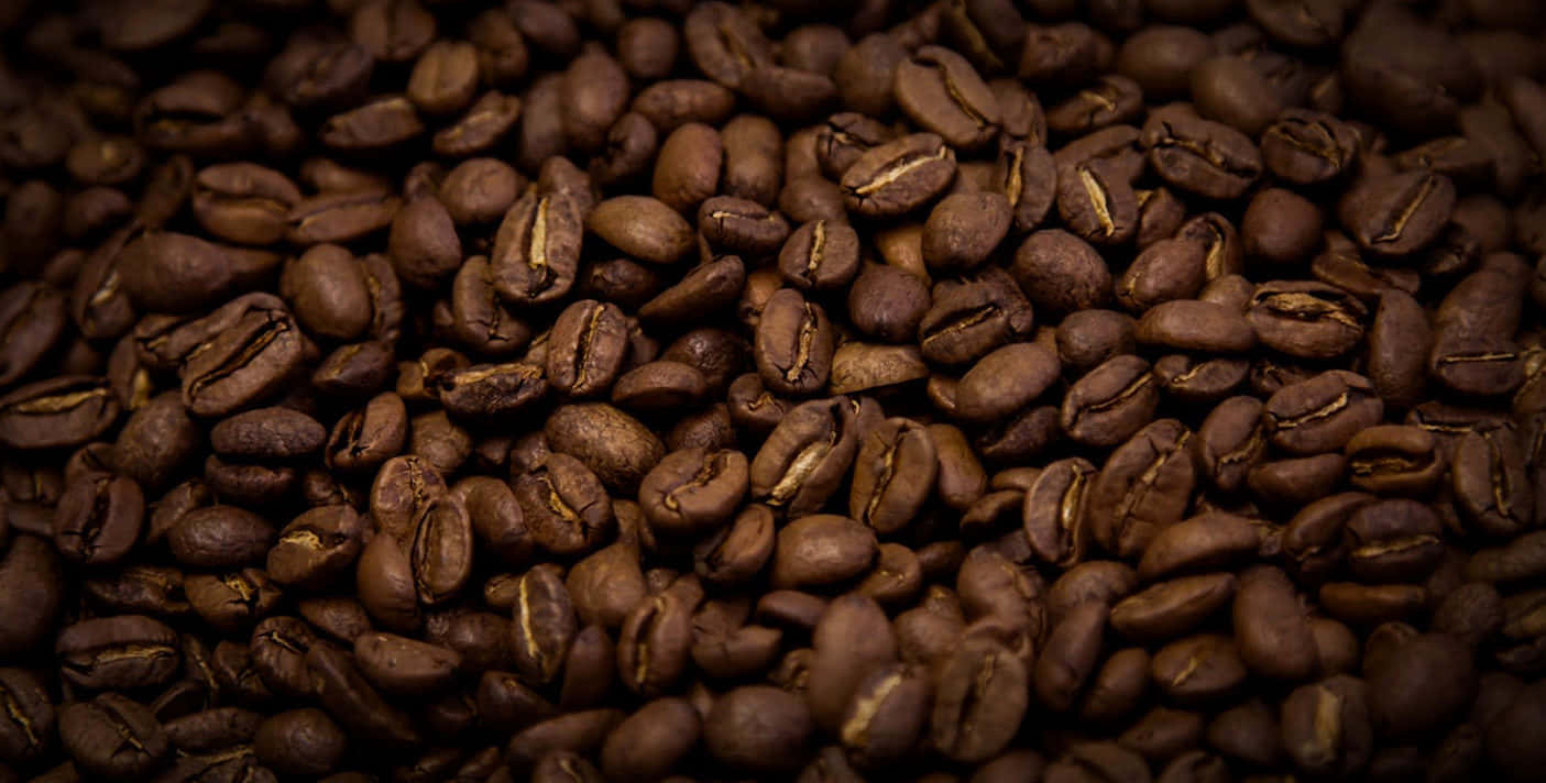 Freshly Brewed Brown Coffee with Aromatic Beans Wallpaper