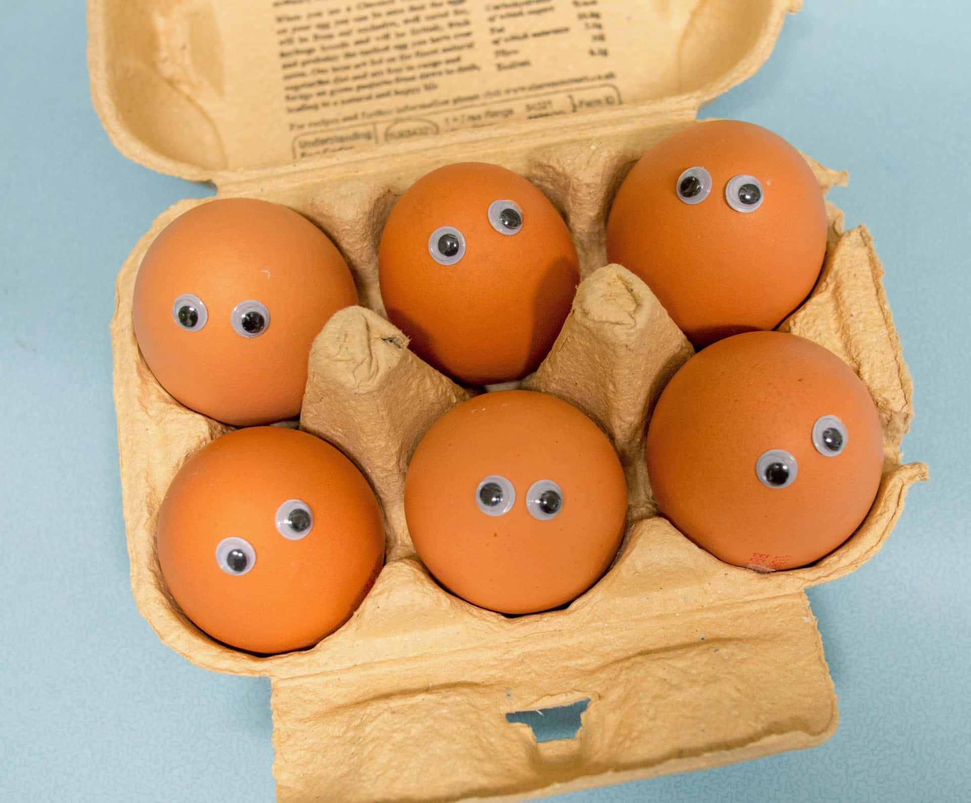 A cluster of fresh brown eggs on a rustic wooden table Wallpaper