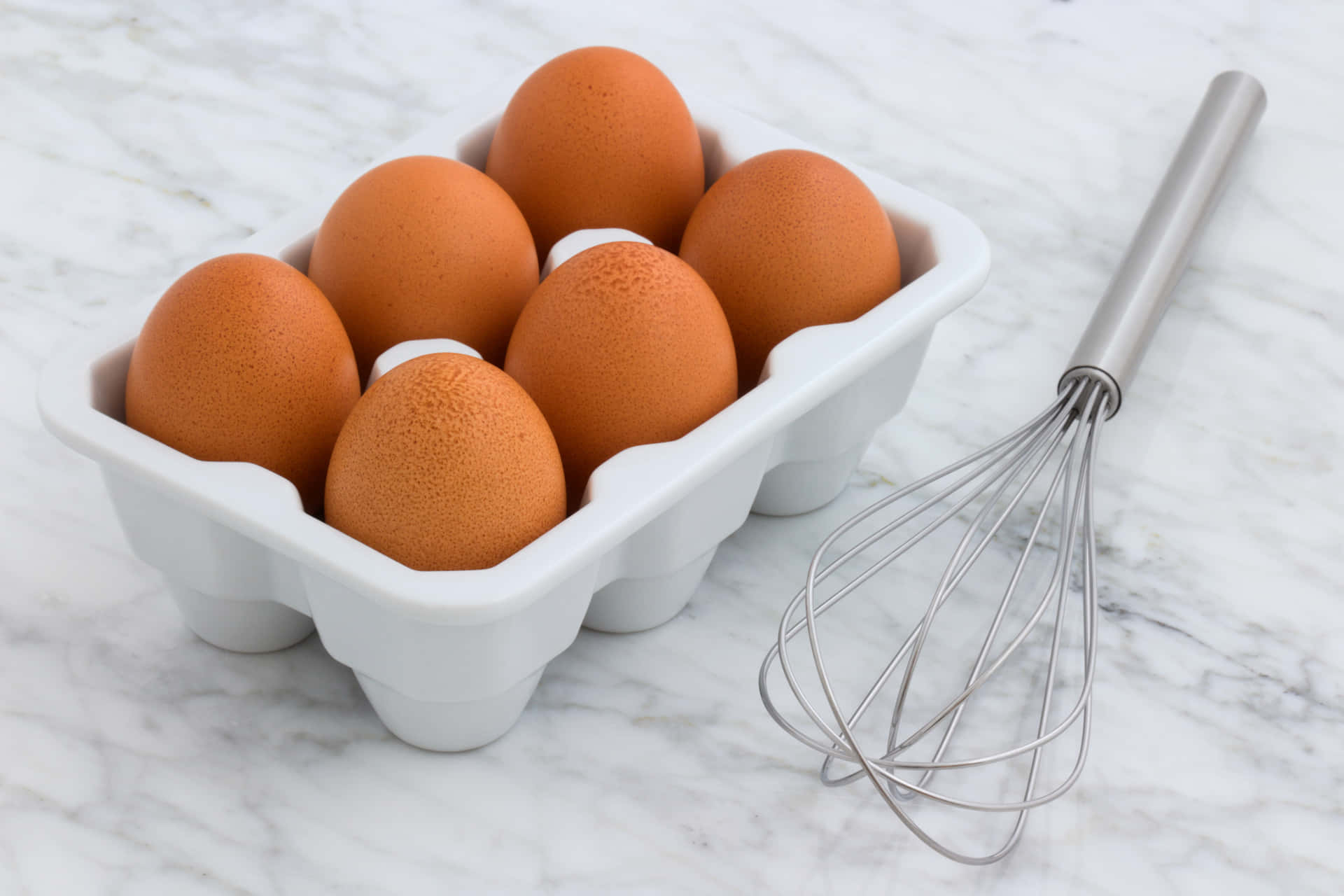 A close-up view of fresh brown eggs neatly arranged in a line Wallpaper