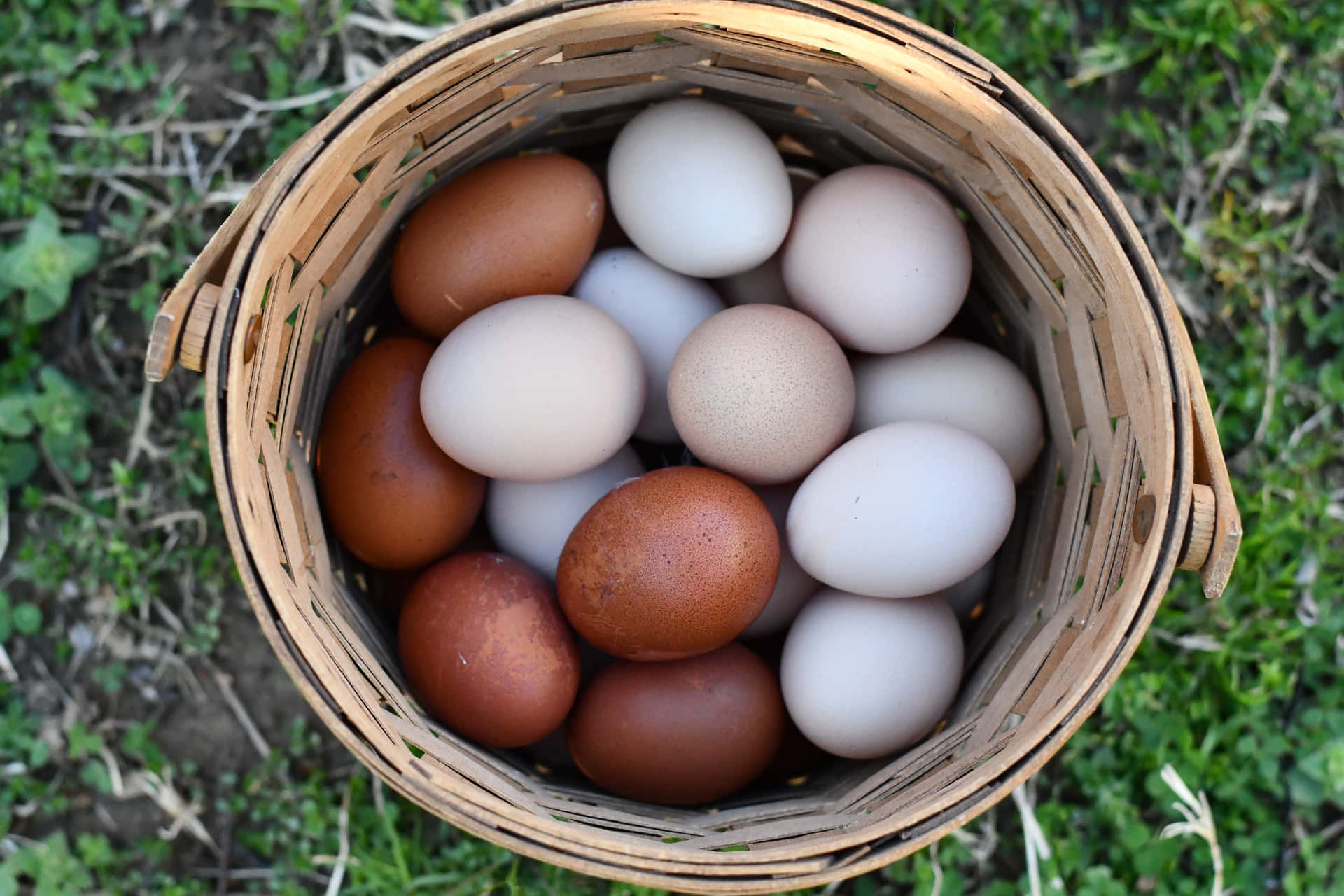 A collection of fresh brown eggs on a rustic wooden surface Wallpaper