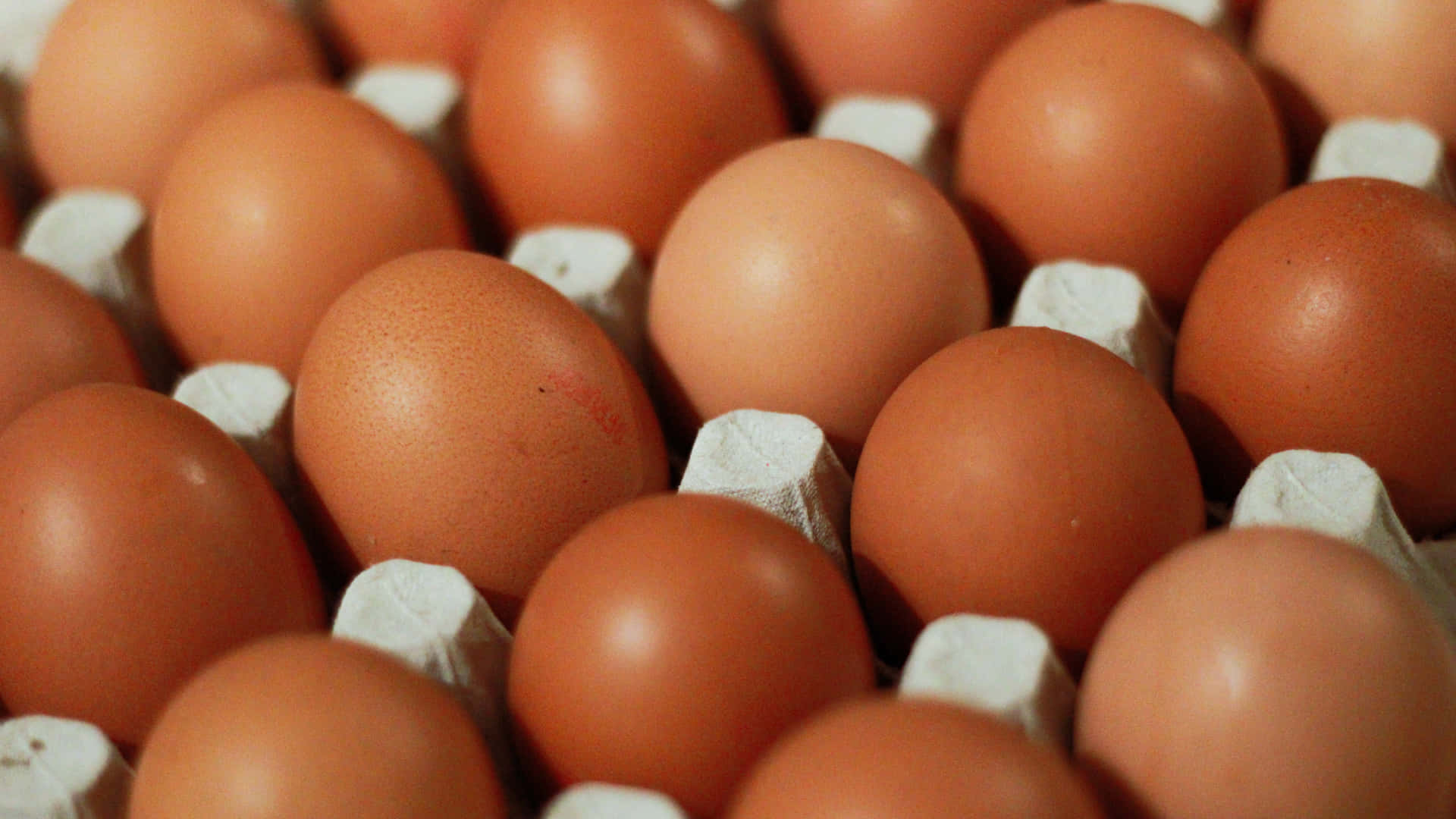 Fresh Brown Eggs on a Rustic Wooden Surface Wallpaper