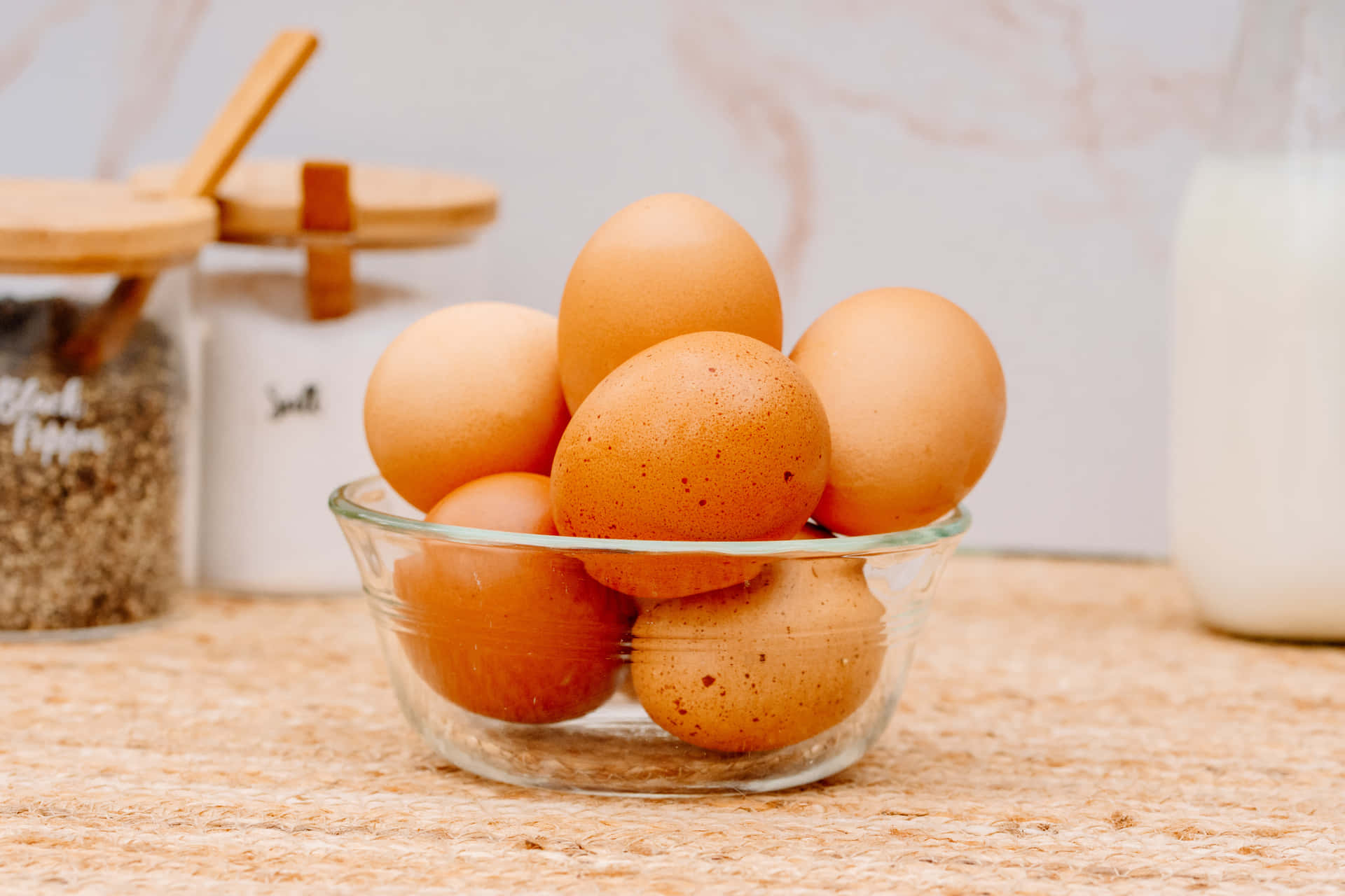 A Close-up of Brown Eggs in a Wooden Basket Wallpaper