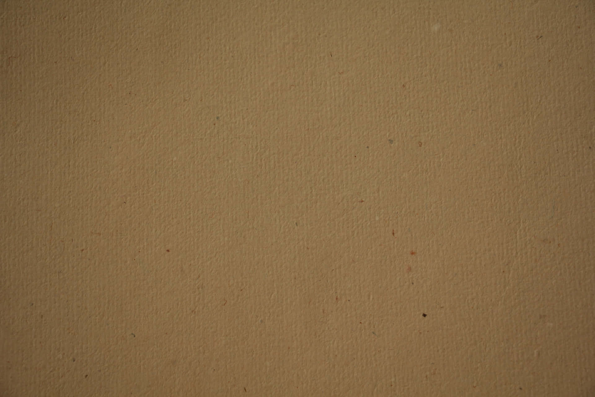 A Brown Paper Background With A Few Spots