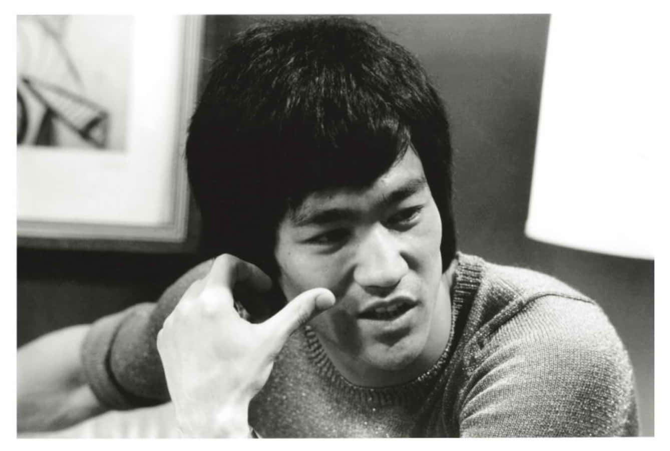 Bruce Lee strikes a classic pose demonstrating his signature fighting style