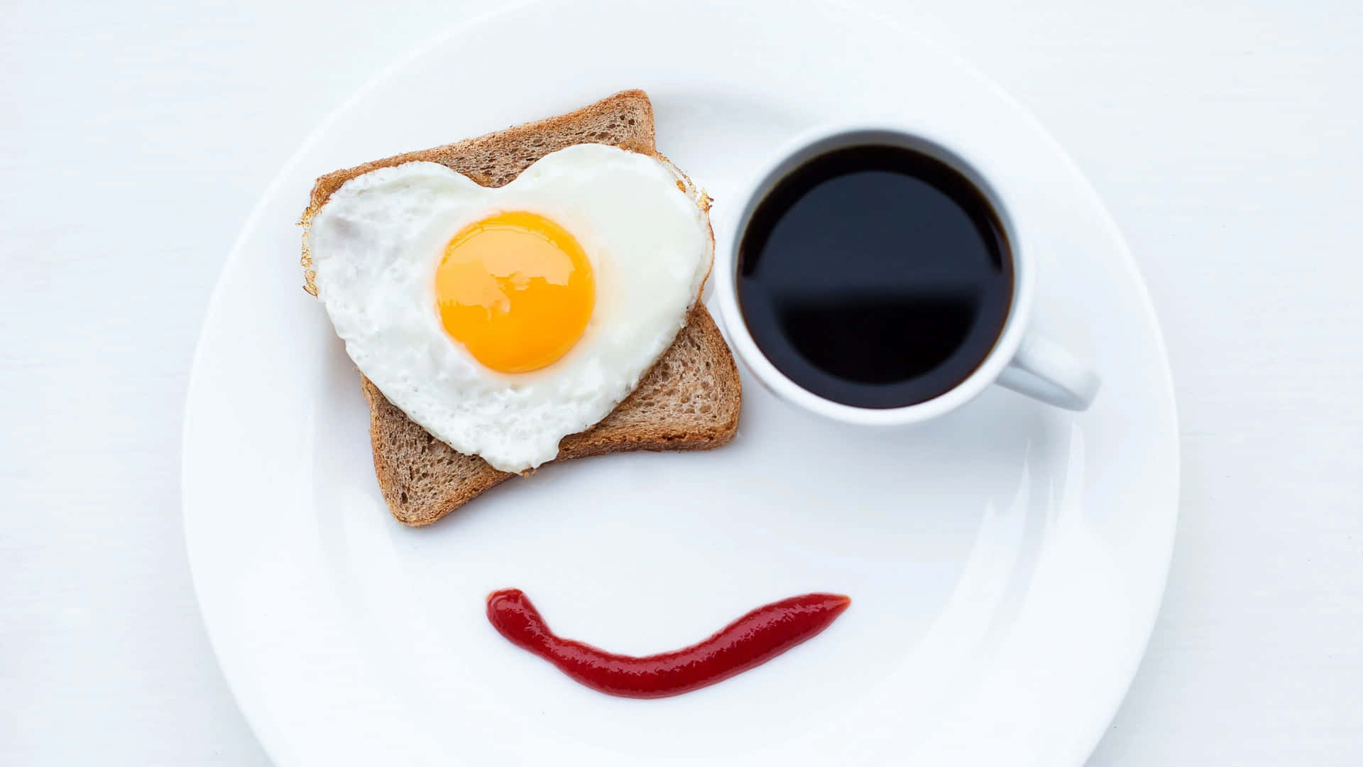 A Plate With Toast And An Egg In The Shape Of A Smile