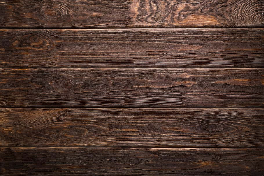Beautiful natural brown wood texture background Wallpaper — Close-up of dark rustic wooden planks with rich grain patterns and warm amber highlights.