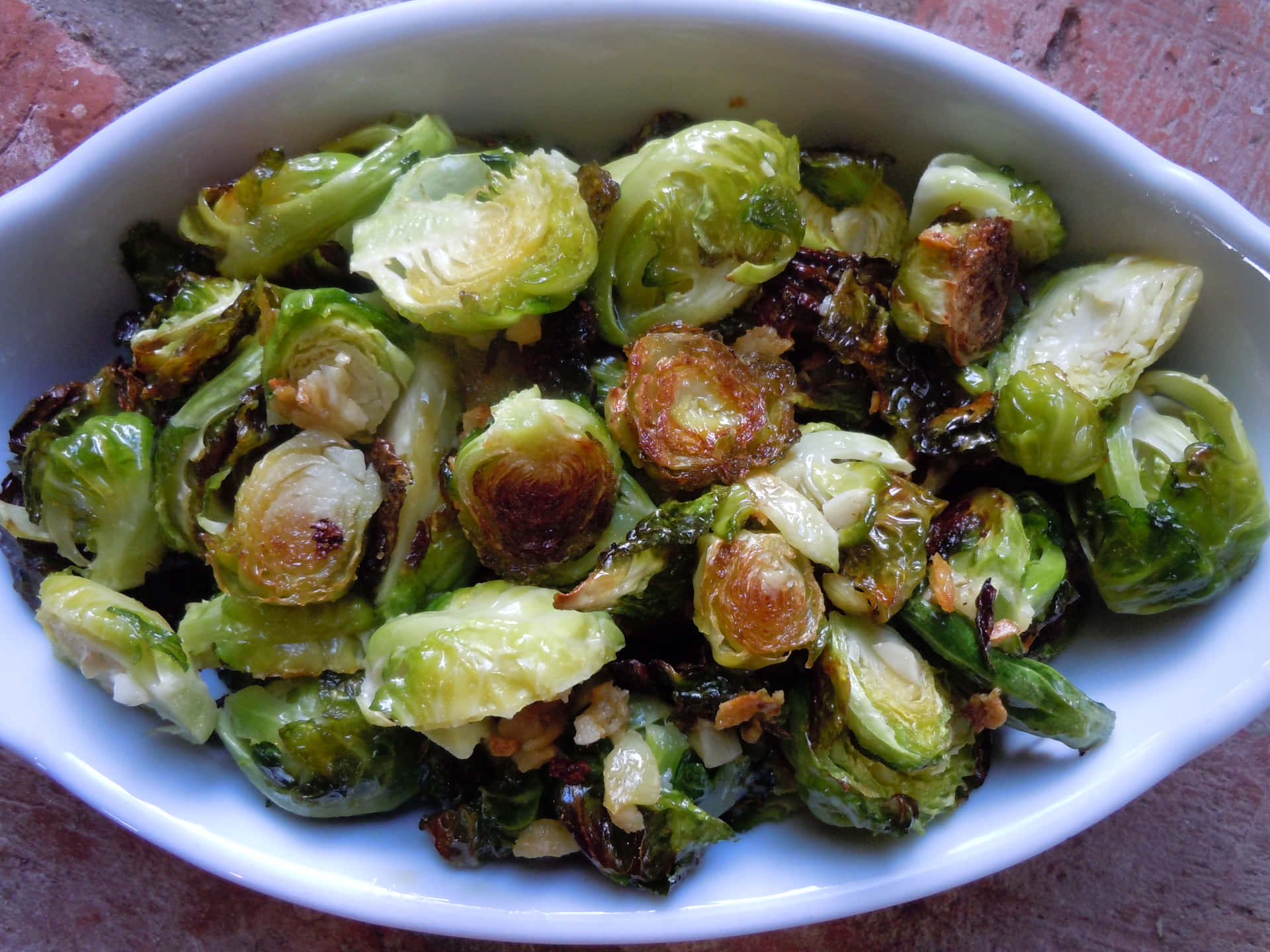 Brussel Sprouts In A White Bowl With Nuts