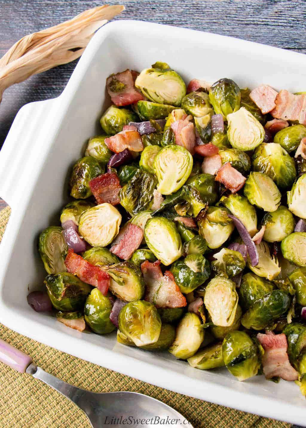 Brussel Sprouts With Bacon And Onions In A White Dish
