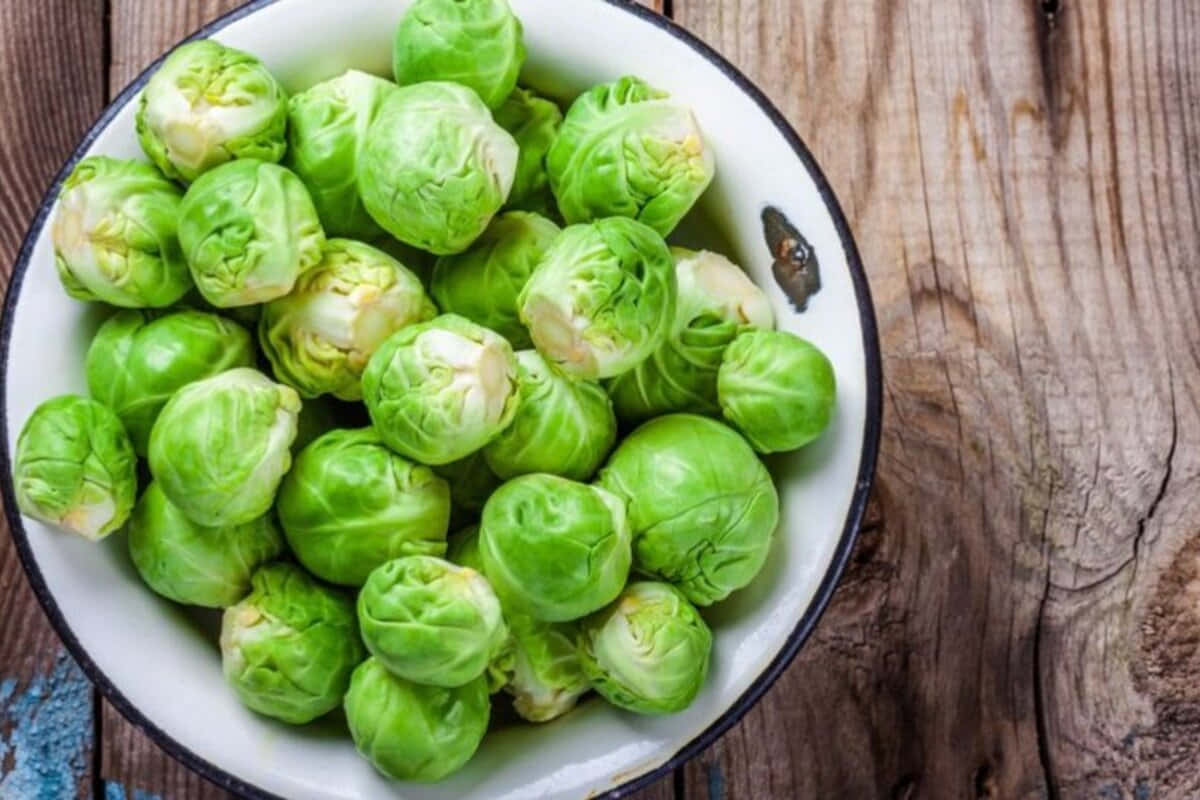 Brussel Sprouts In A Bowl On A Wooden Table