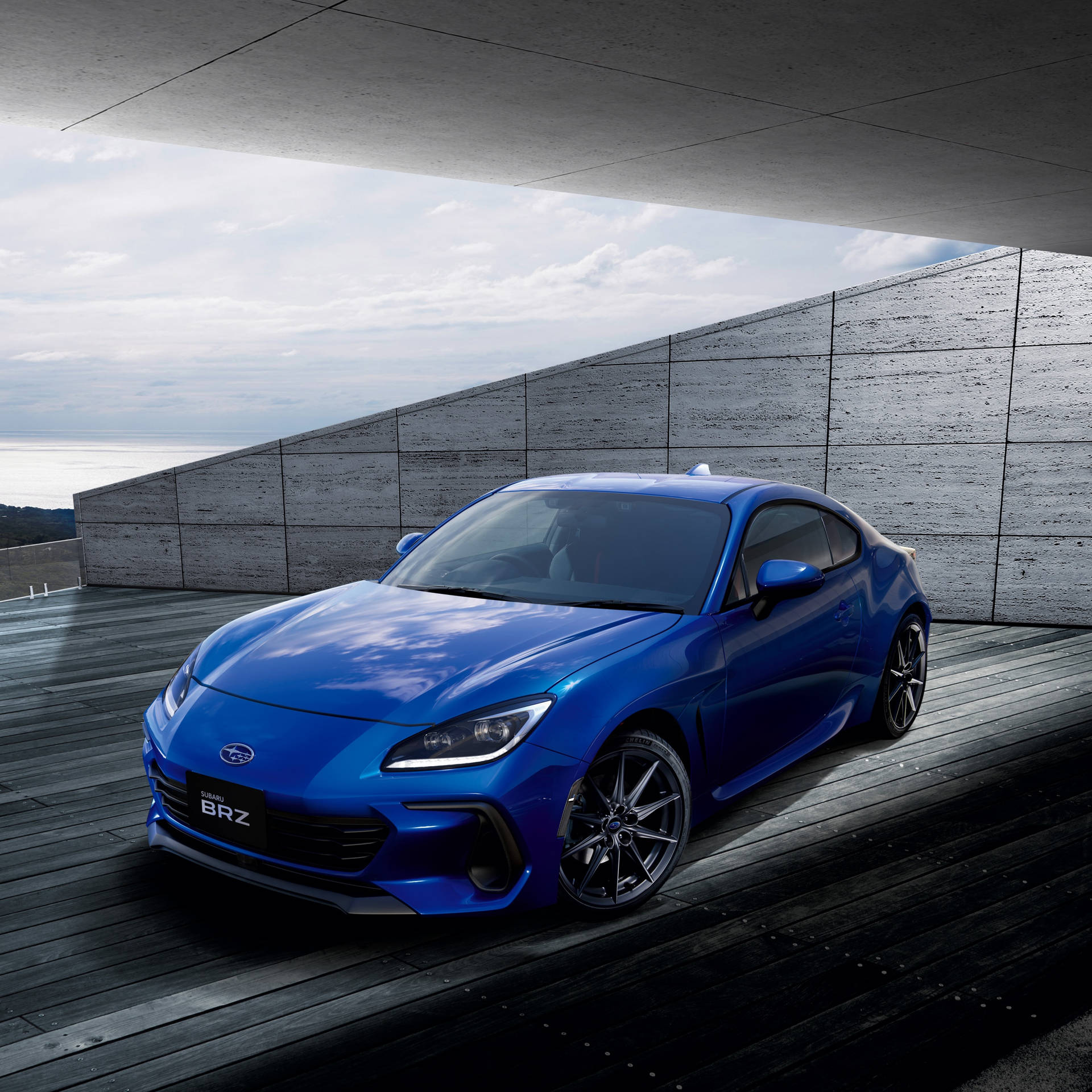 The Blue Toyota 86 Sports Car Is Parked On A Concrete Floor Wallpaper