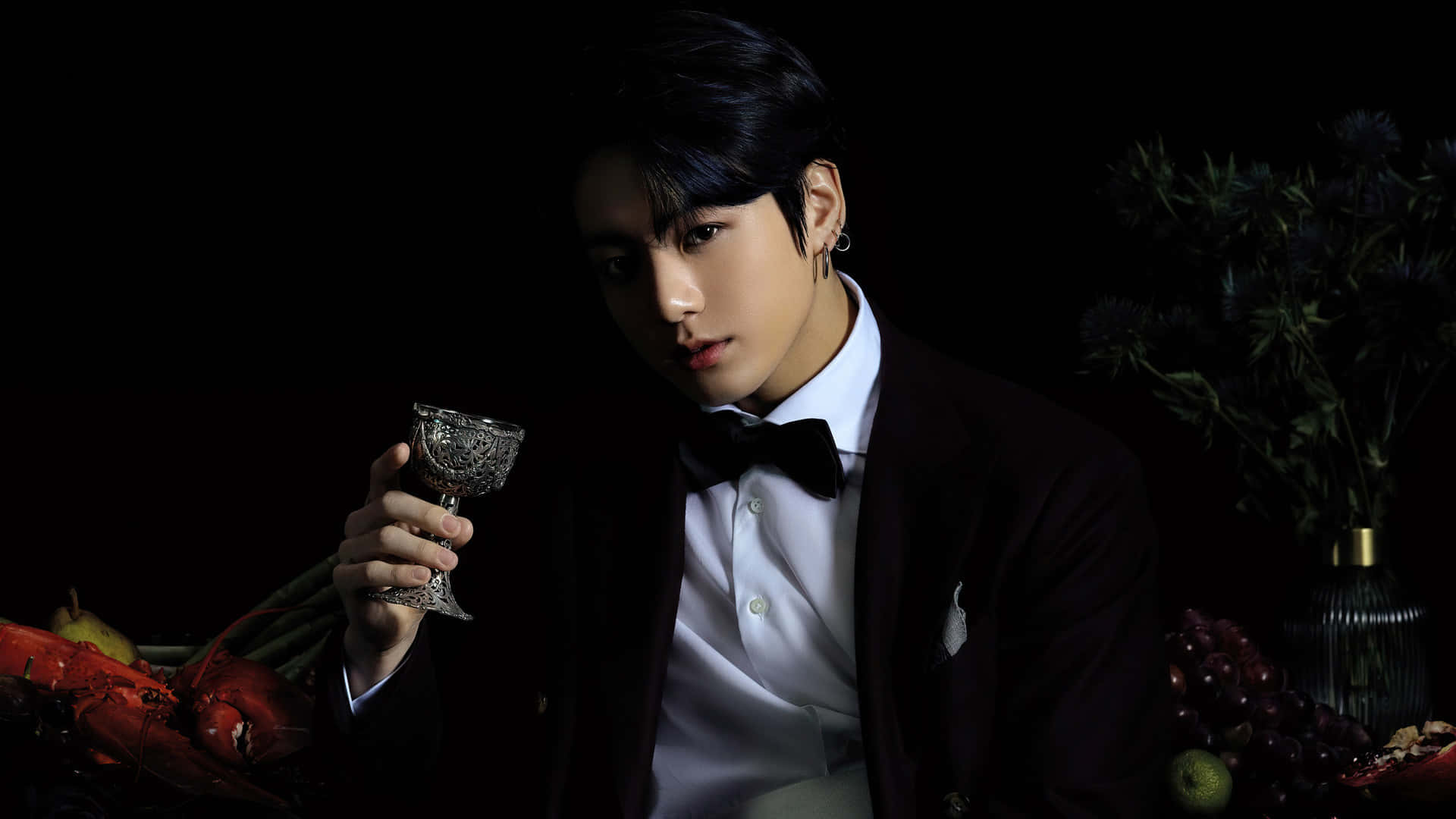 A Man In A Suit Holding A Glass Of Wine Wallpaper