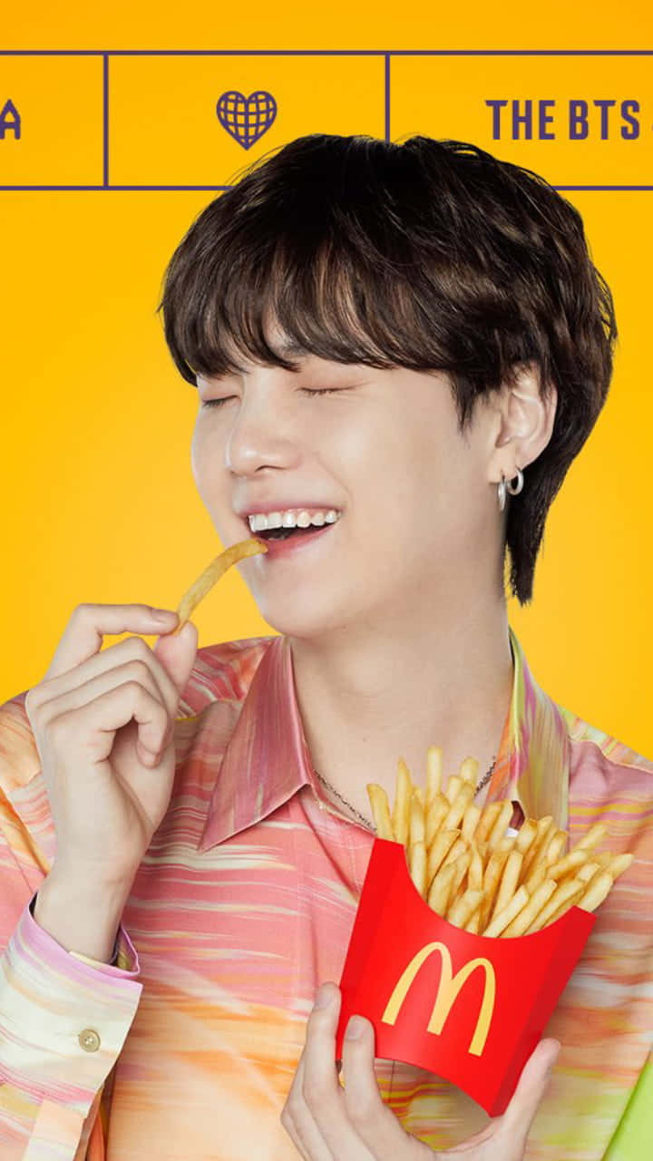 A Man Is Eating French Fries With A Bts Shirt Wallpaper