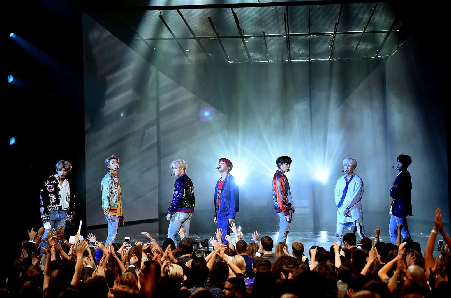 Electrifying BTS performance at a live concert Wallpaper