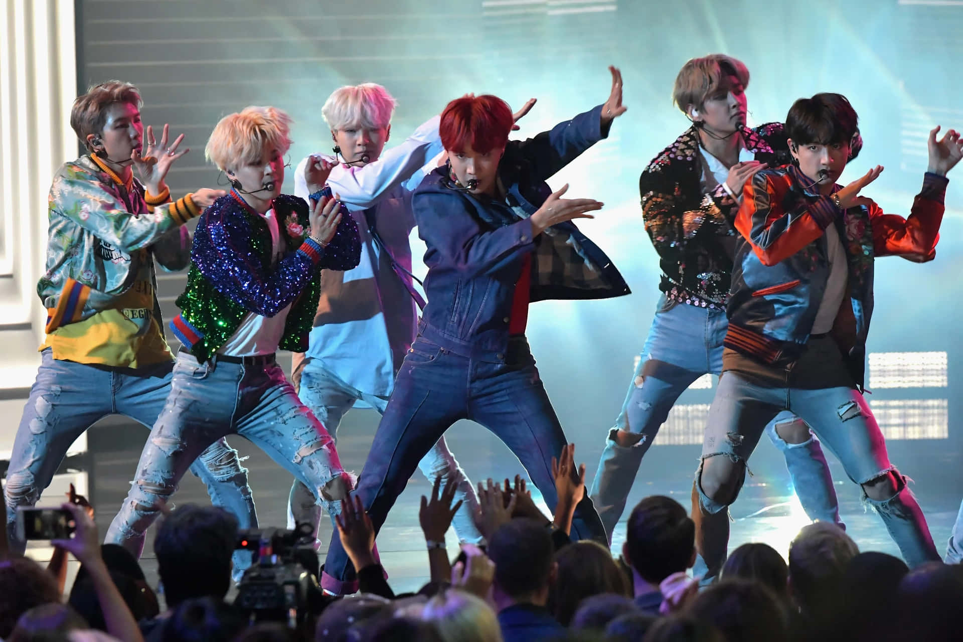 BTS performs at a concert, showcasing their incredible stage presence. Wallpaper