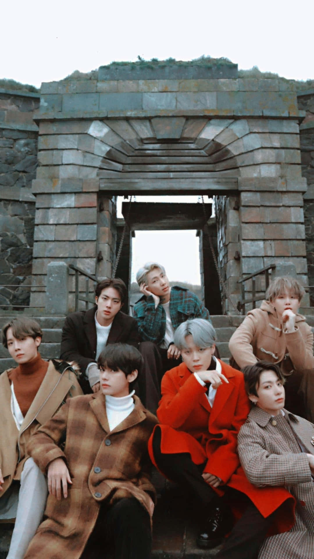 BTS Photoshoot Sitting On Stone Staircase Wallpaper