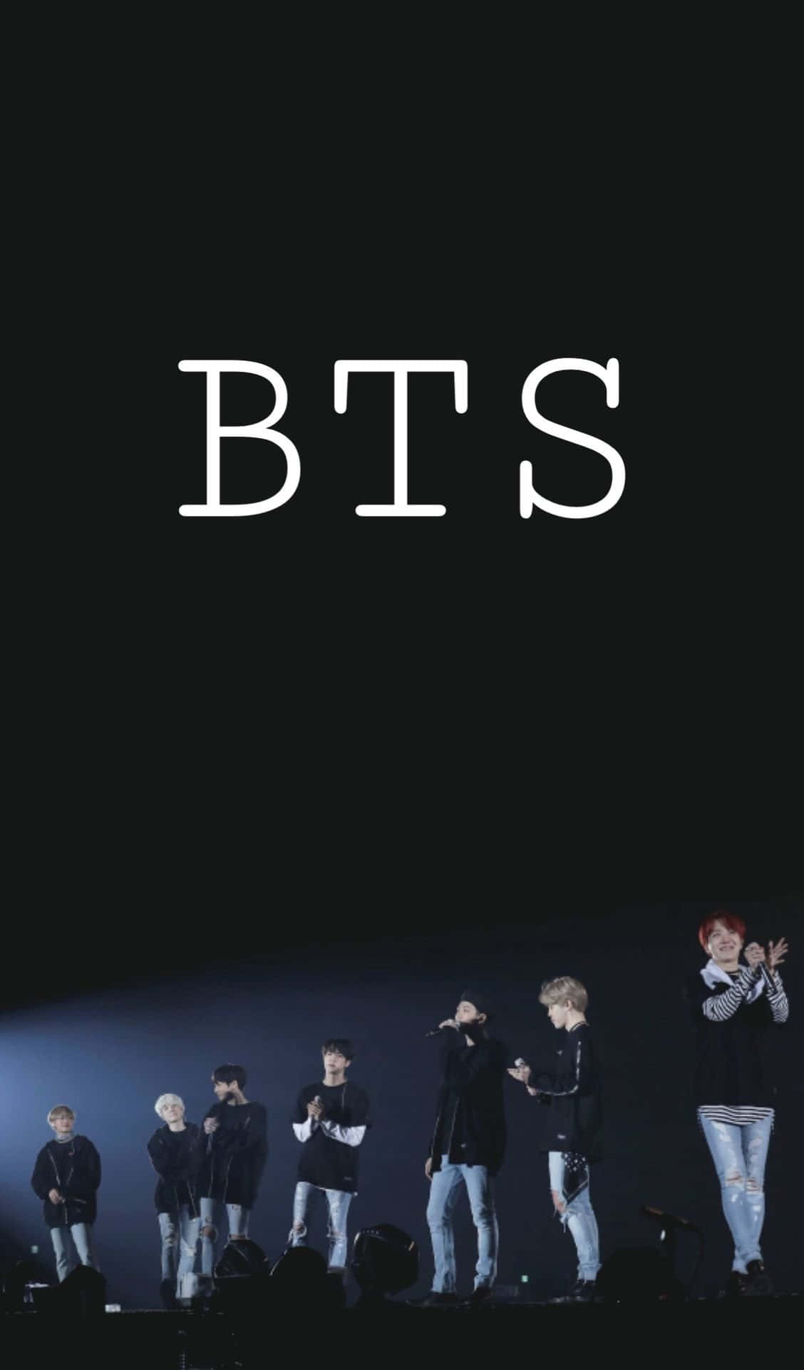 BTS performing on stage in front of their fans Wallpaper