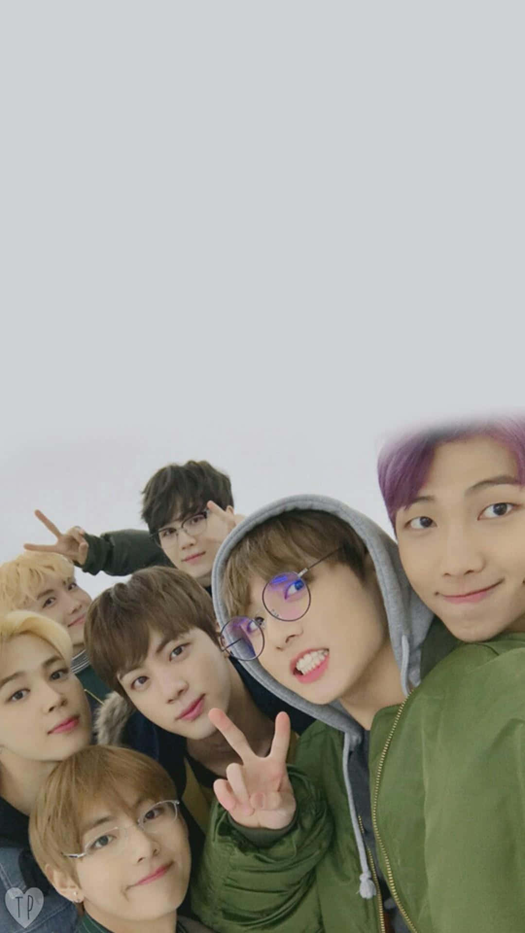 BTS iPhone Selfie Wallpaper — Seven young men with colorful hair and glasses pose cheerfully in a selfie against a plain white background.