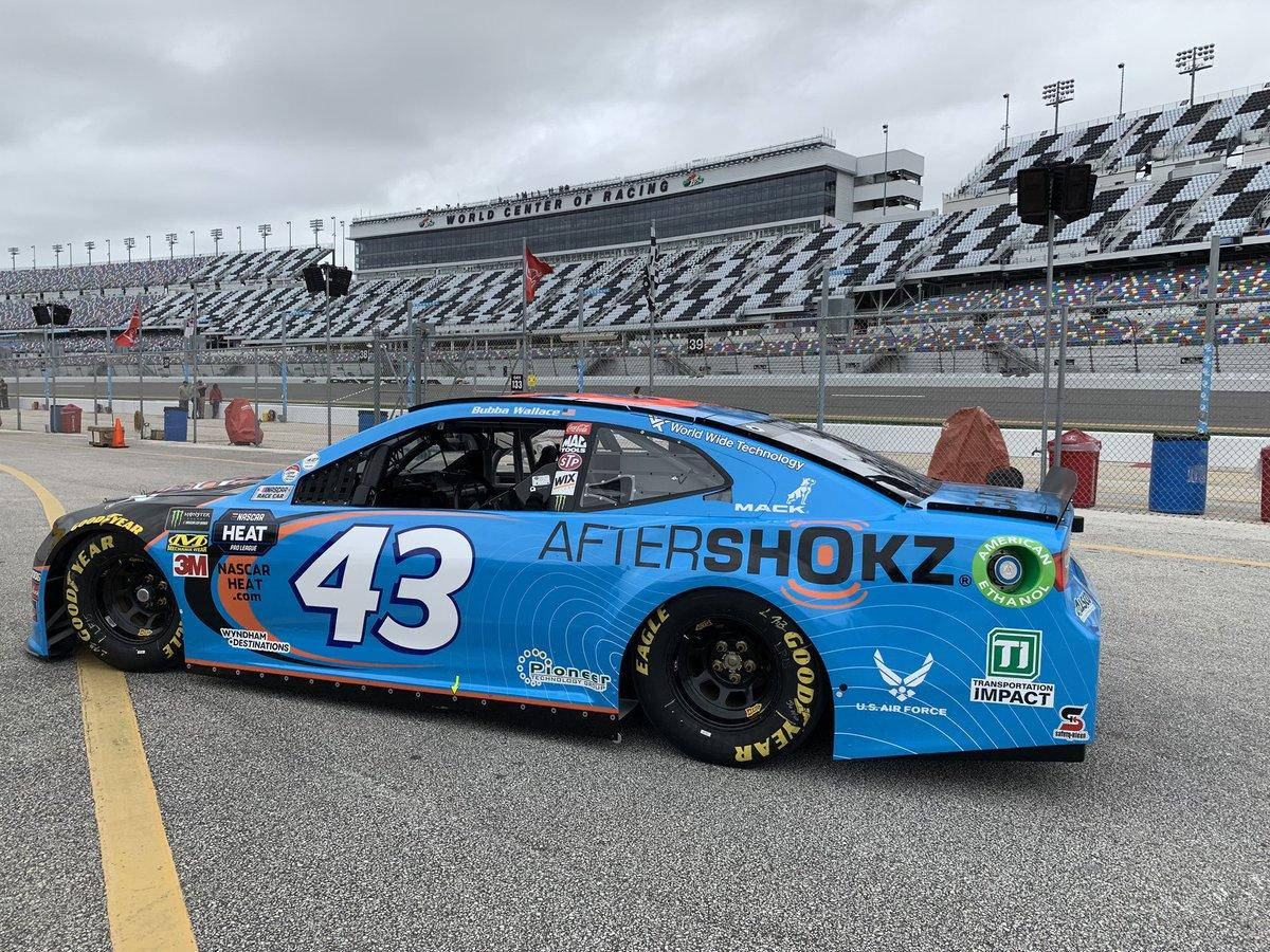 Bubba Wallace Competing in Car Racing with Aftershokz Blue Car Wallpaper