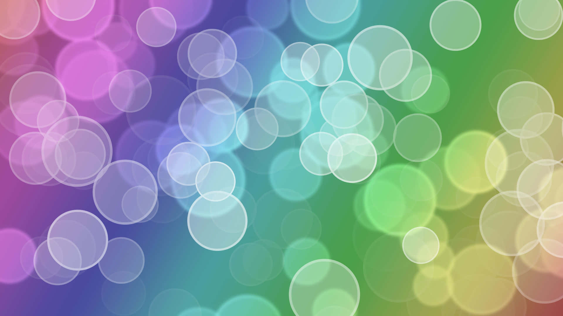 Reflekterende bobler med en regnbue baggrund.