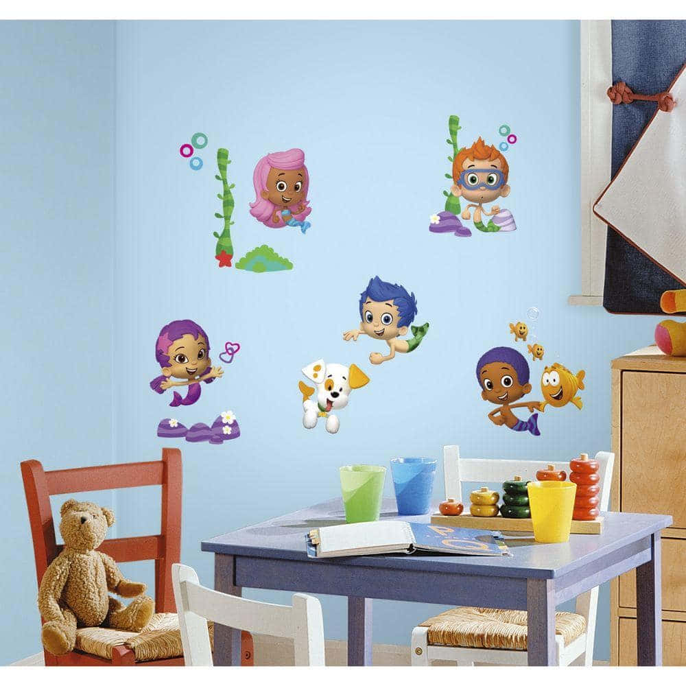 a child's room with a wall decal featuring a mermaid and a merman