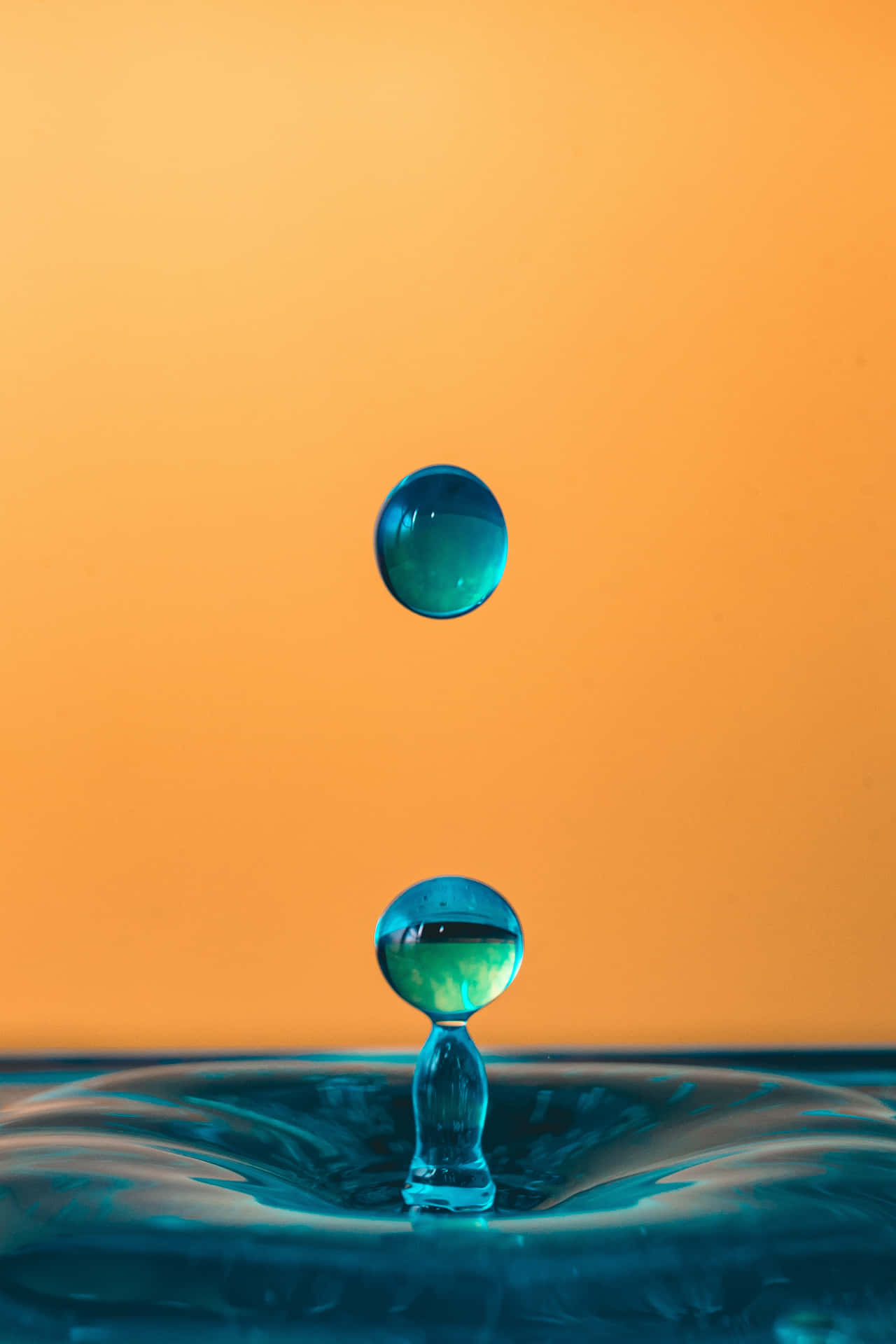 Two Water Drops Falling Into A Blue Water