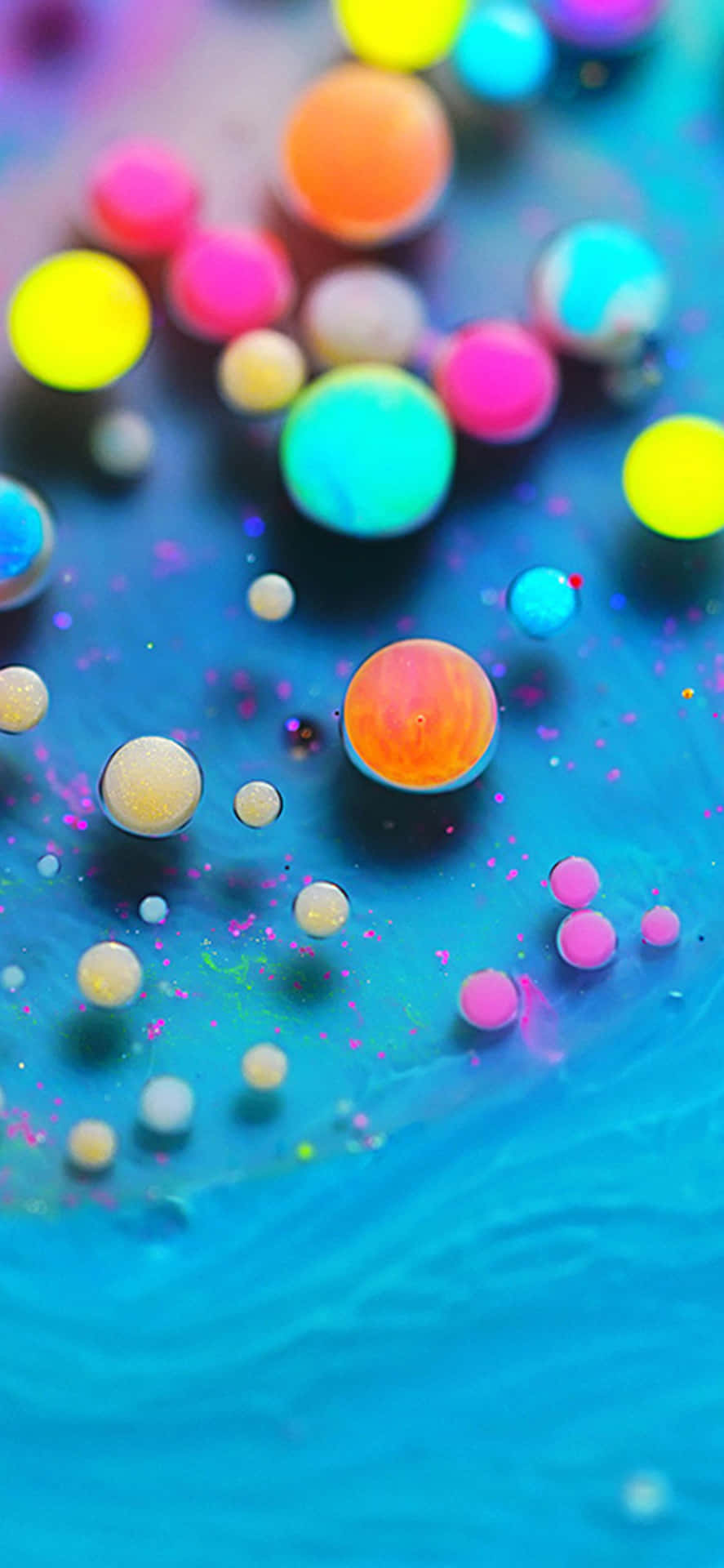 Colorful Bubbles Floating In A Blue Liquid Wallpaper