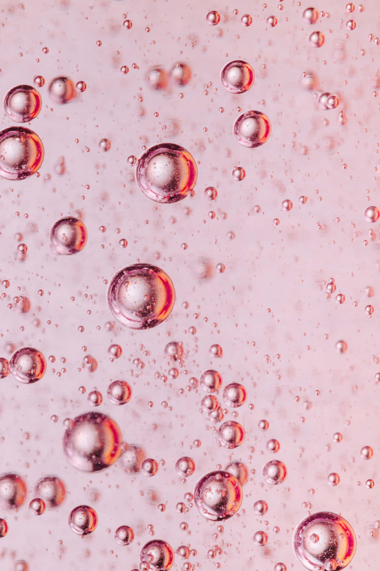 A Close Up Of Bubbles In A Pink Liquid