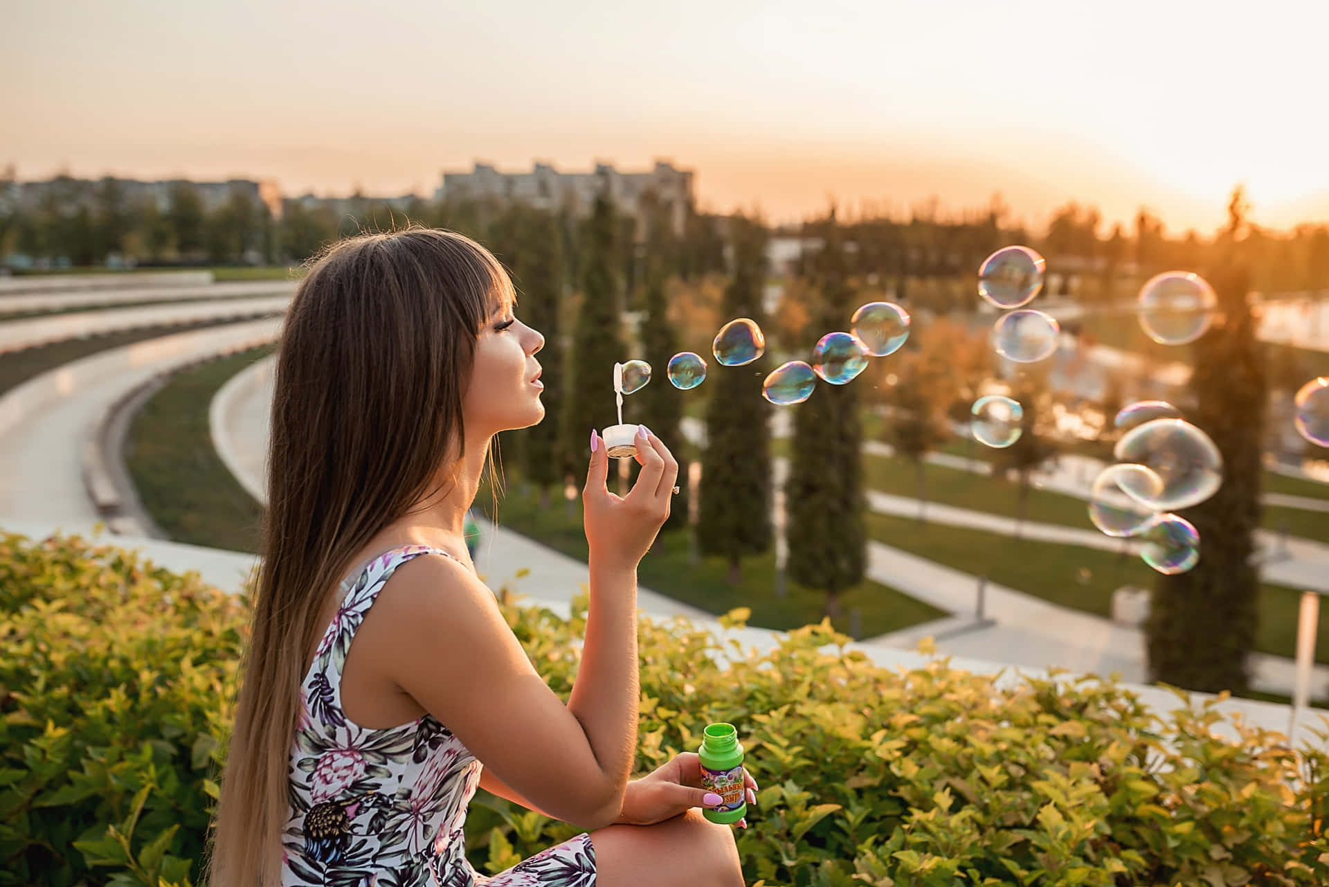 A Woman Blowing Soap Bubbles In The Park