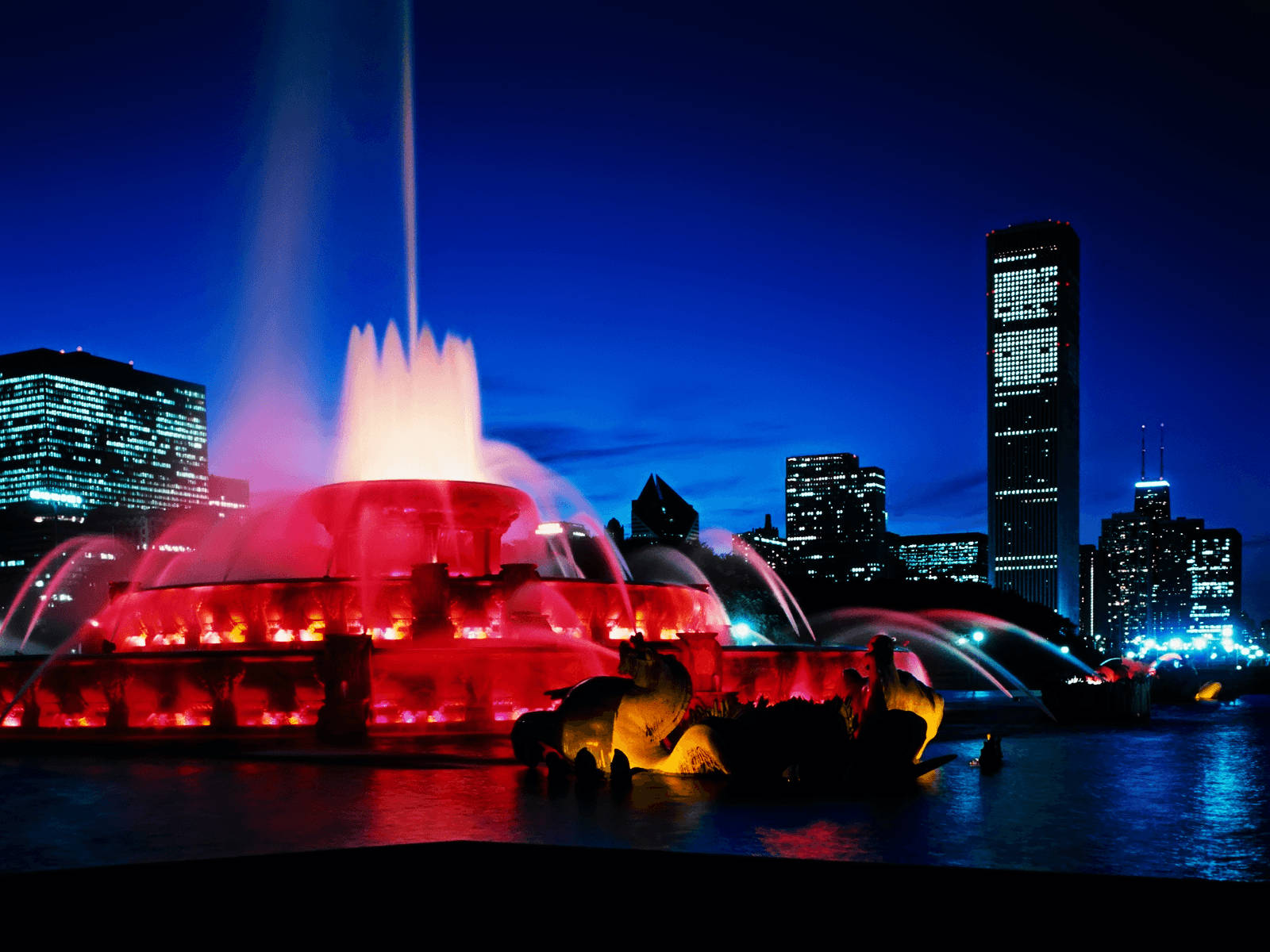 Majestic View of the Buckingham Fountain Set Against the Chicago Skyline Wallpaper